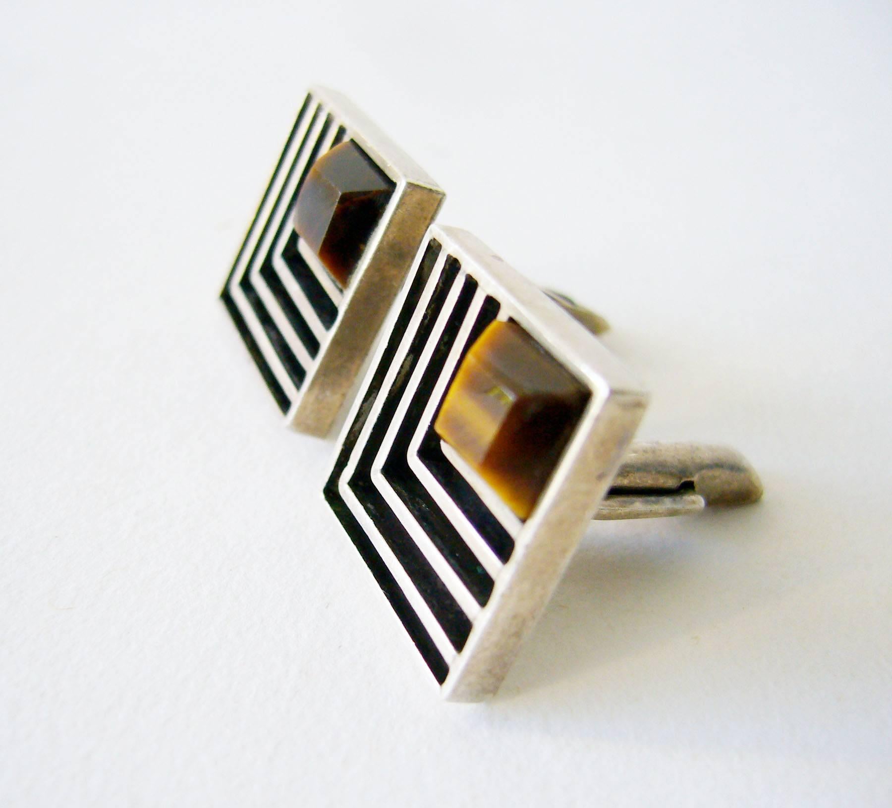 Mexican sterling silver and tiger's eye geometric modernist cufflinks created by Cecilia Toño circa 1960.  Cufflinks measure .75" by .75" and feature faceted square tiger eye stones.  Signed Toño on verso and in very good vintage