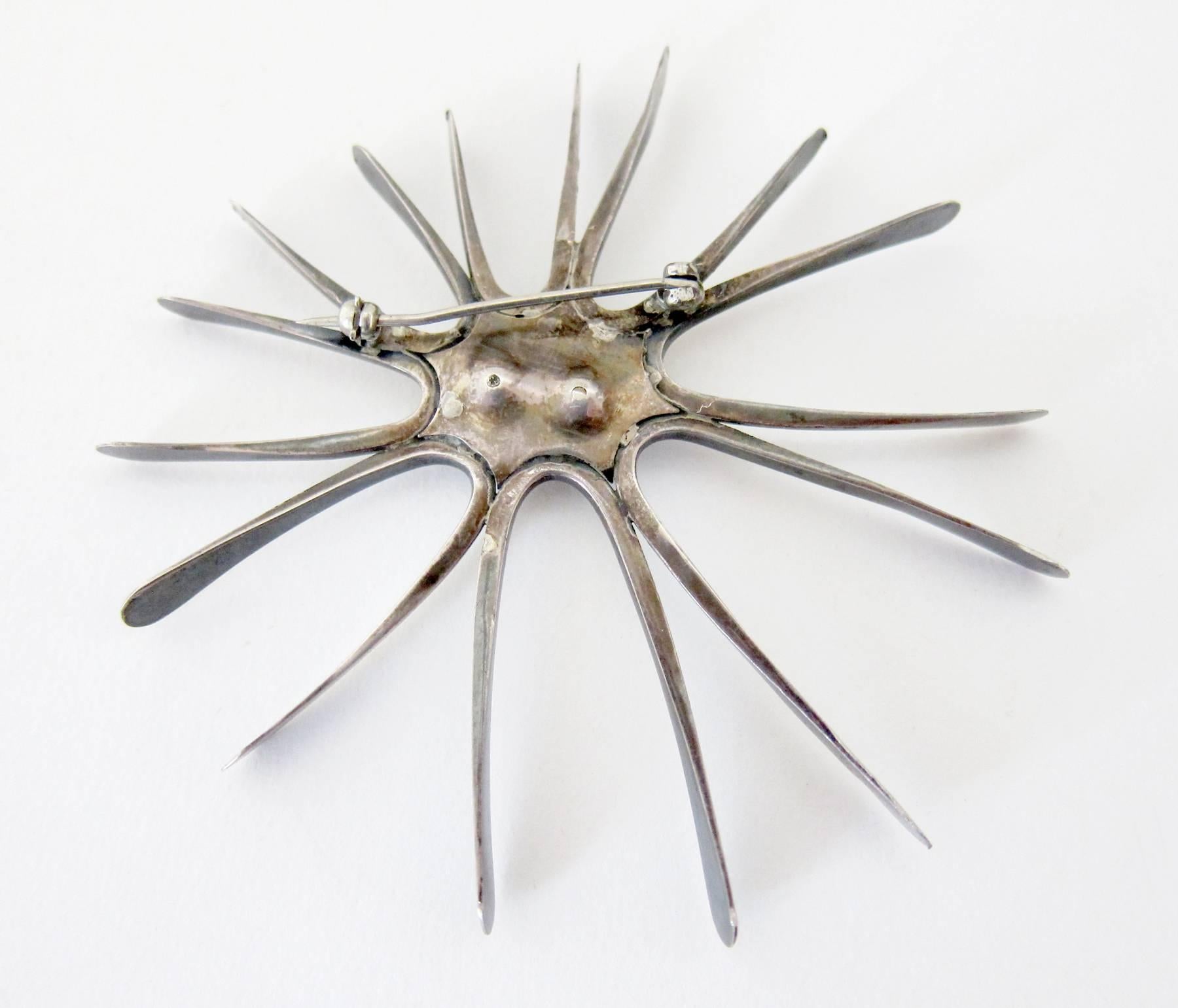Large scale sterling silver and pearl starburst brooch created by woodworker and jeweler Robert Trout of Southern California.  
Trout's woodworking, jewelry and furniture were included in most Pasadena Museum of Art California Design exhibitions. 