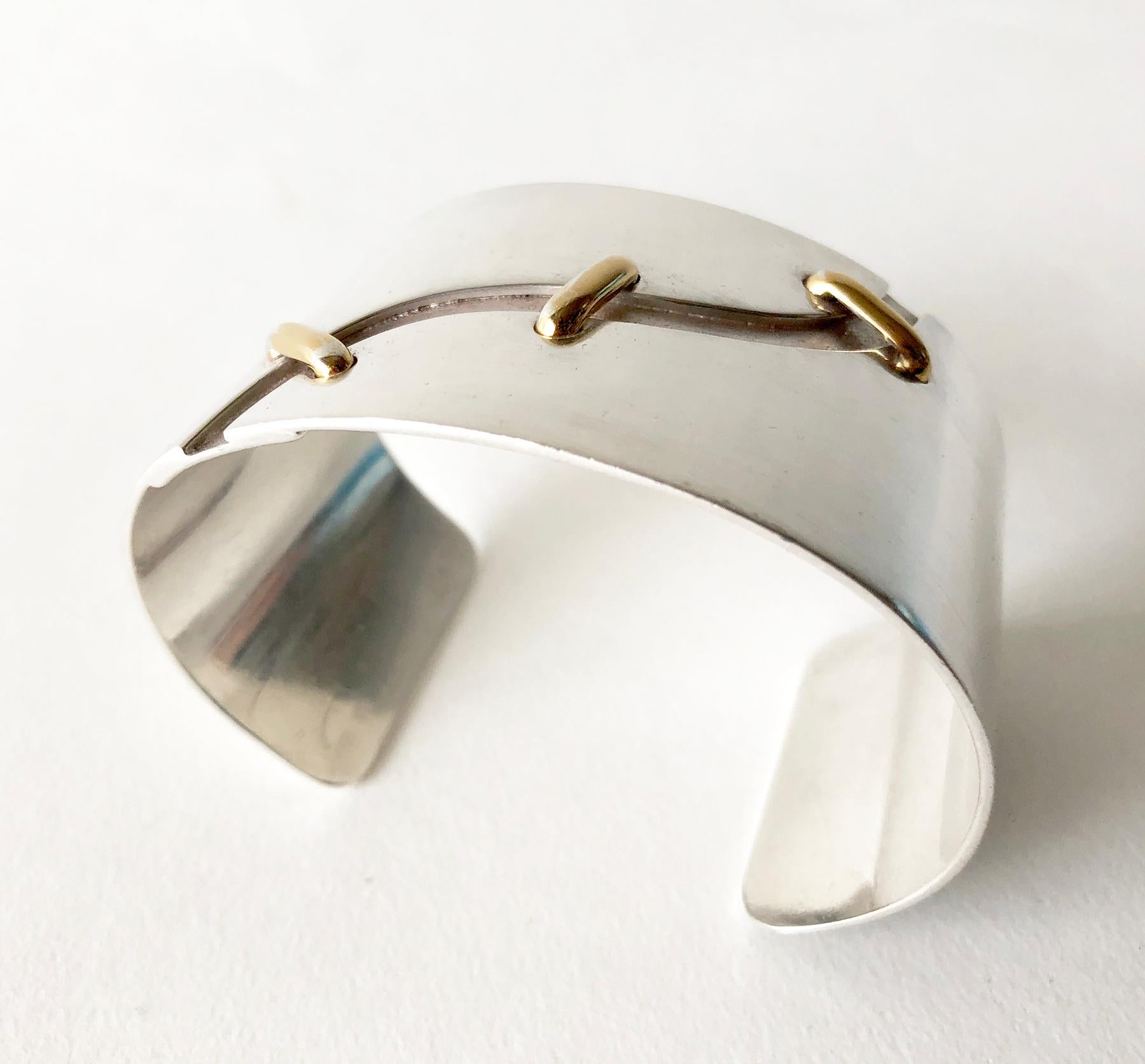 1970s sterling silver cuff bracelet with 14k gold 'stitched' accents created by José Maria Puig Doria of Barcelona, Spain.  Bracelet measures 7