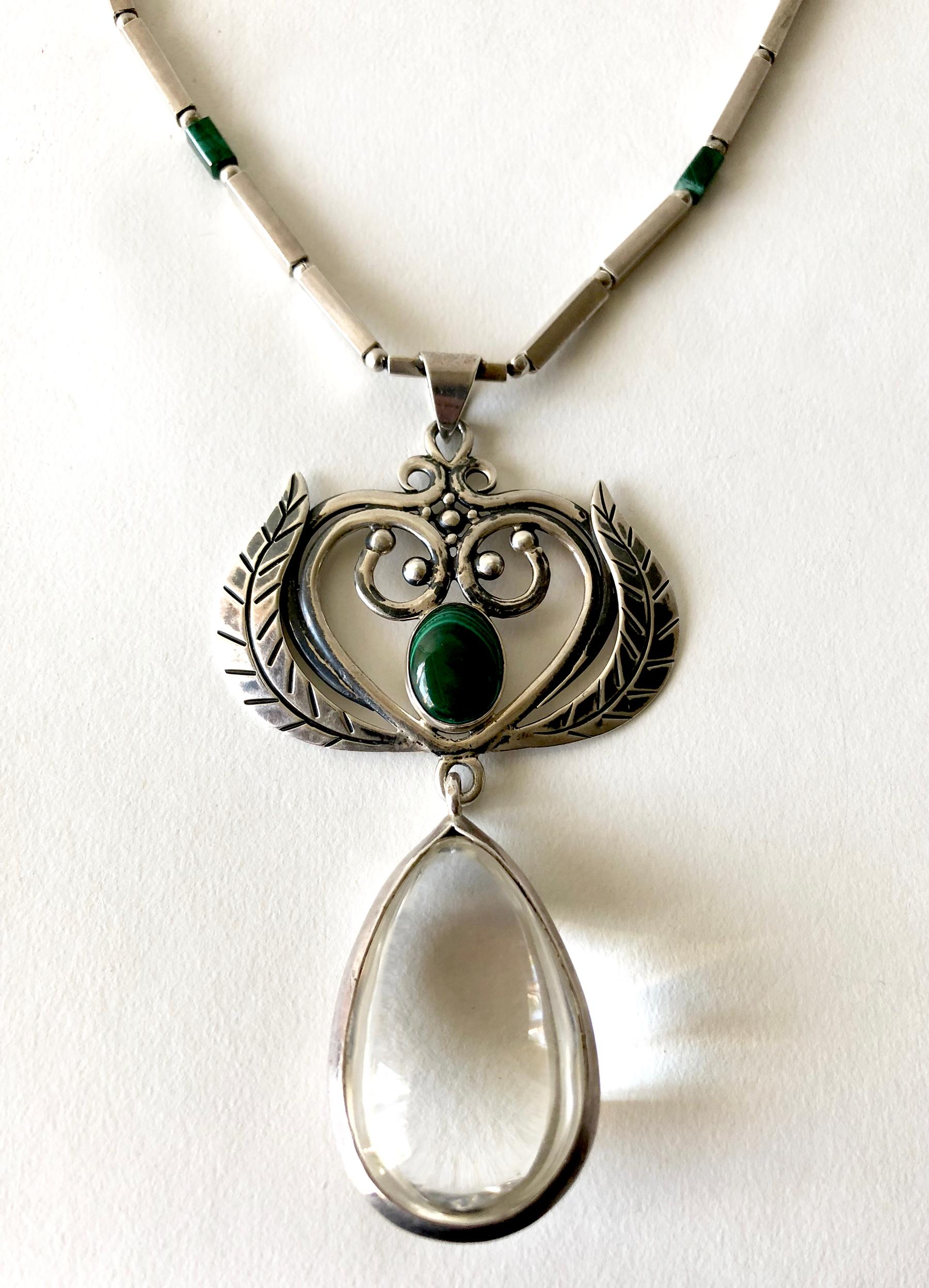 Rare, sterling silver necklace with malachite stone at pendant center and beads within the chain by Los Castillo of Taxco, Mexico.  Pendant also features a gorgeous large, bulbous, teardrop shaped rock crystal which measures 2