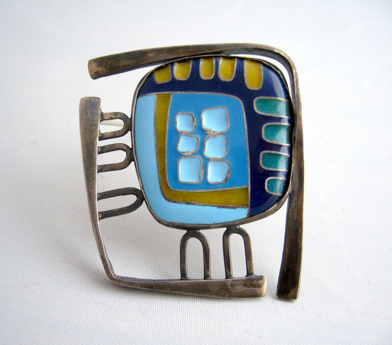 An enamel over sterling brooch of abstract design created by Polly Stehman of Yakima, Washington.  Brooch measures 1 3/4