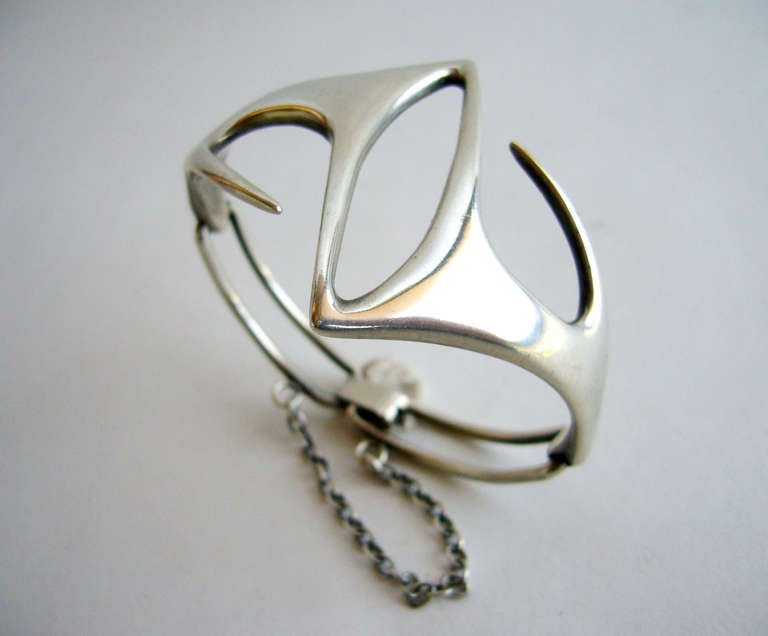 A hinged sterling silver bracelet of abstract design created by Irvin and Bonnie Burkee of Arizona.  Bracelet measures about 6.5