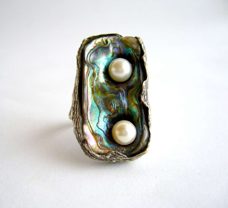 Modernist freshwater two pearl ring set in an abalone shell face created by jewelry artist Ursula Hammil.  Rings face measures 1.5