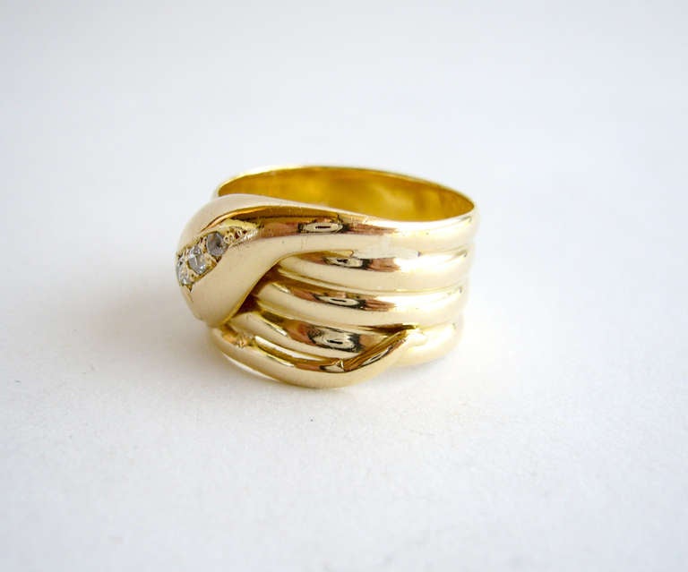 An 18k gold wide snake ring with diamond eyes dating from the 1940's.  Suitable for a man or woman, ring is a finger size 9.5 and weighs 9.2 grams.  British hallmarks. In very good vintage condition.