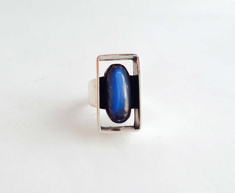 A sterling silver and moonstone ring created by Henry Steig of New York circa 1950's.  Ring features a gorgeous elongated blue moonstone encased within a blackened shadow box setting.  A finger size 7.5 and signed Steig, Sterling.  In excellent