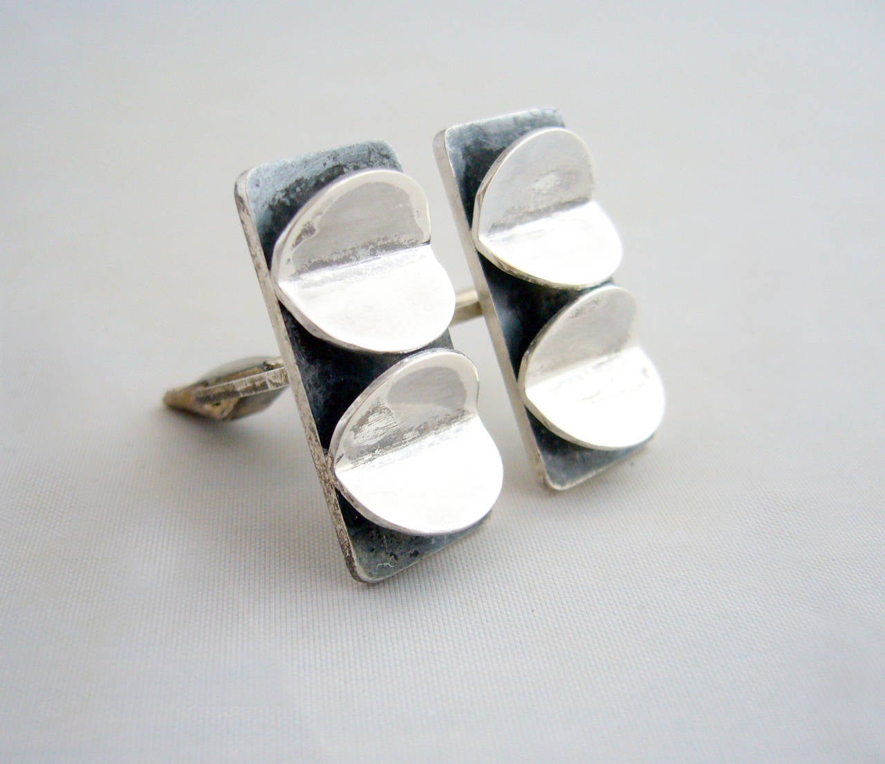 Sculptural sterling silver mid-century American modern cufflinks signed with an unknown hallmark of a hand scribed 