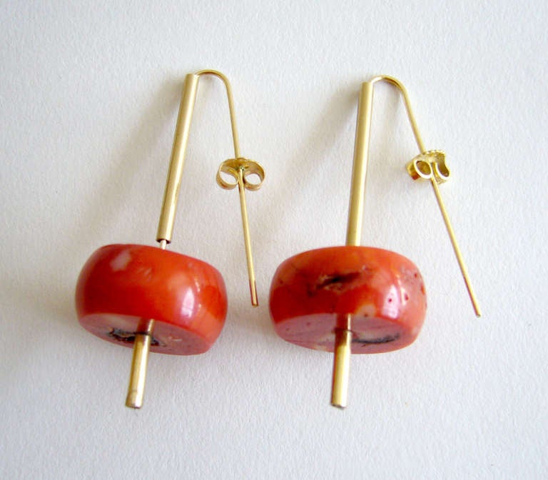 A pair of 14k gold and Chinese coral earrings created by Betty Cooke of Baltimore, Maryland.  Pierced earrings measure 2