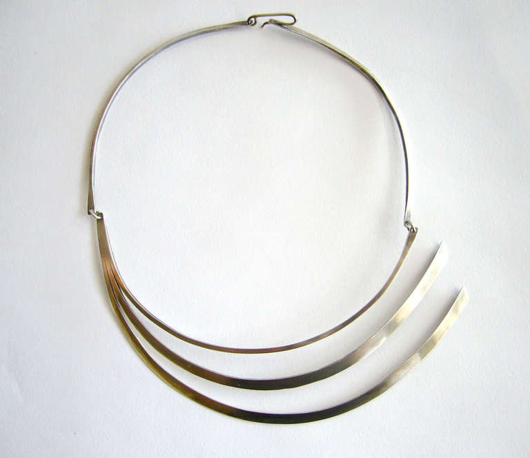 Early sterling silver necklace designed and created by Betty Cooke of Baltimore, Maryland.  Elegant in design, the necklace has 15" of wearable neck length while the pendant drops 2 1/4".  Signed Cooke, Sterling.  In excellent vintage