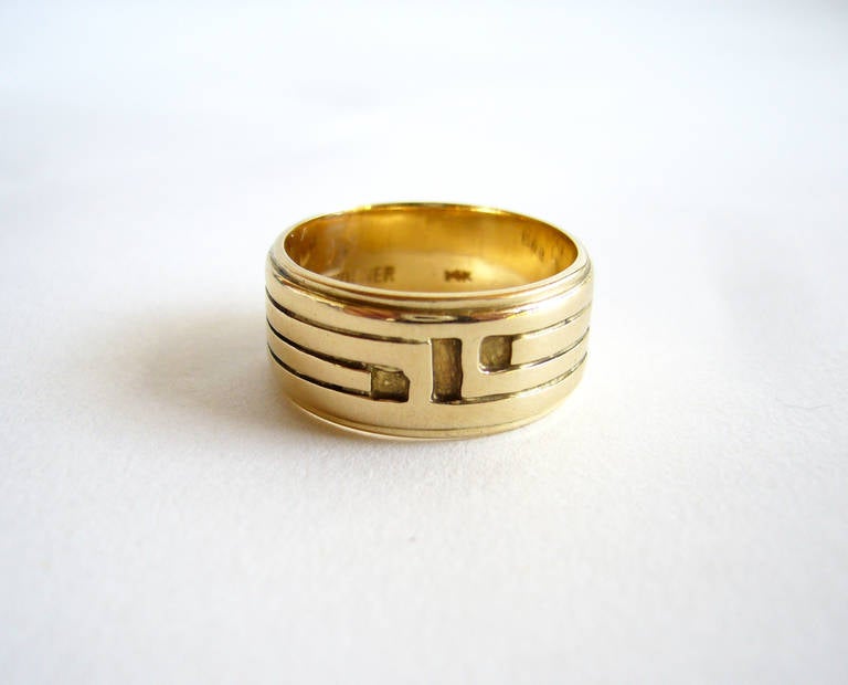 A 14k gold band ring with etched linear design by Ed Wiener of New York.  Ring is 3/8' in width and a finger size 7.  Suitable for a man's pinkie ring.  Signed Ed. Wiener, 14k.  In very good vintage condition.