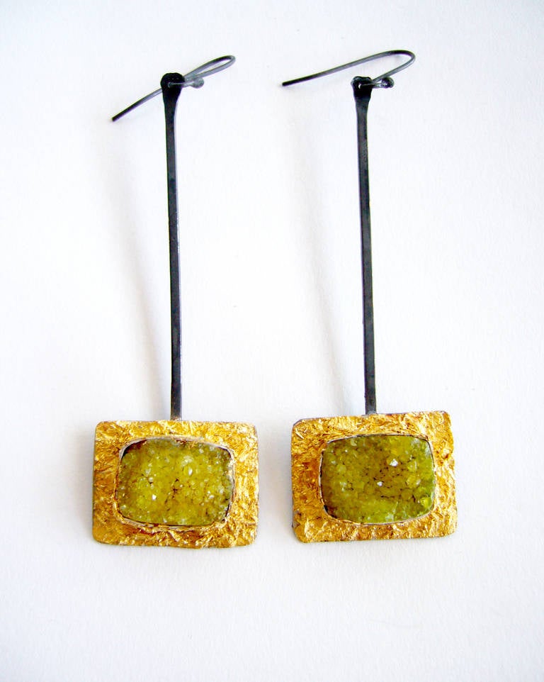 A pair of blackened and gold leafed sterling silver earrings with dyed fall color druzy quartz centers designed and created by Heidi Abrahamson of Phoenix, Arizona. Earrings measure 3 1/2" in length, including the handmade finding and are