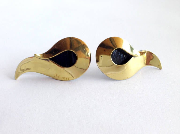A pair of 1950's curled brass earrings created by Art smith of New York City, New York.  Earrings are of the screw back variety and measure 1 7/8