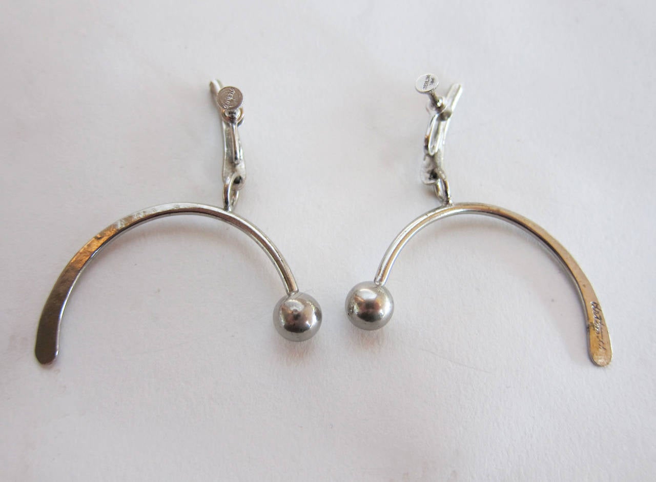 Arched sterling silver earrings with counter balance bead by Art Smith of New York City circa 1950's.  Screwback earrings measure 2.5