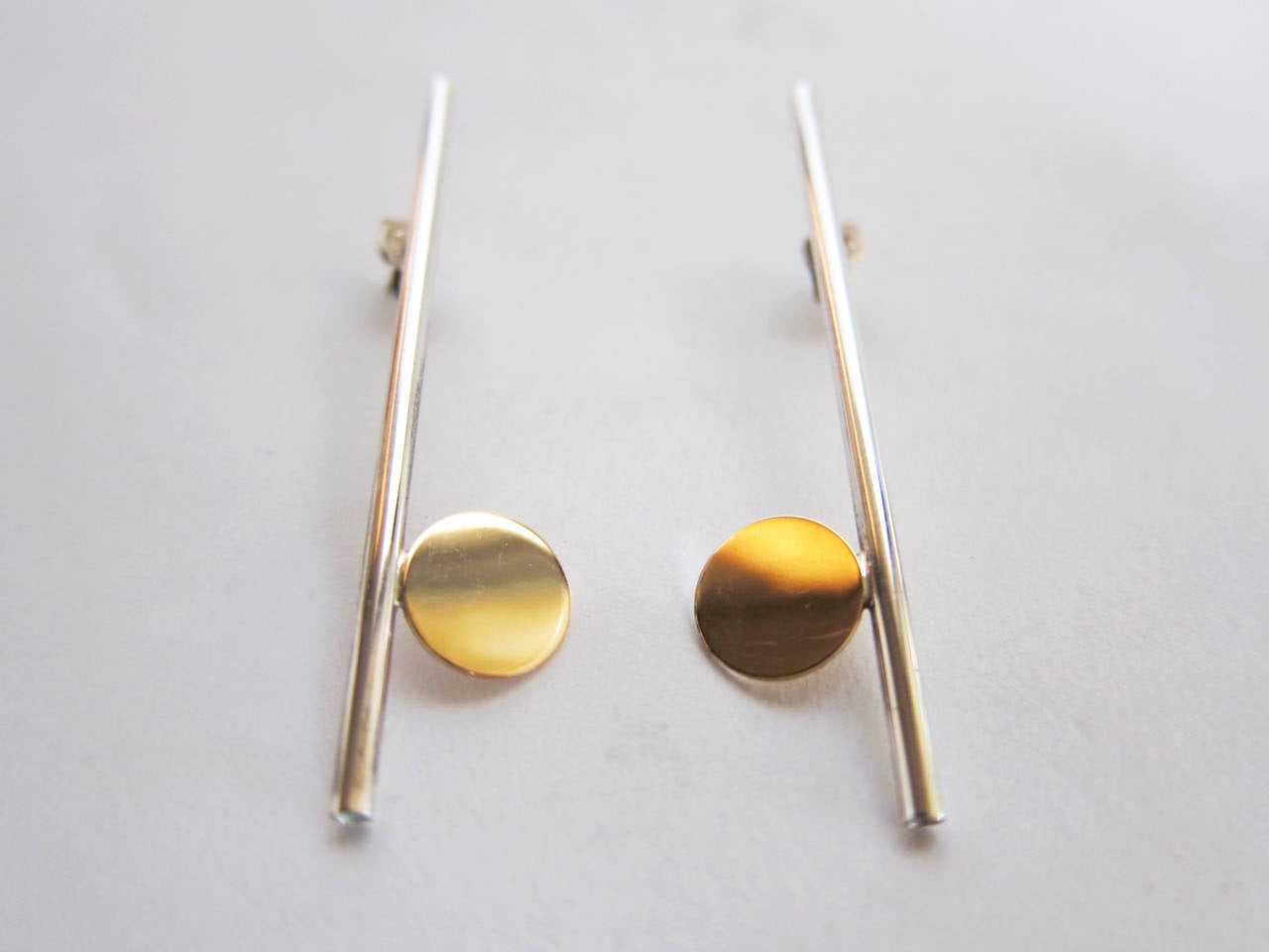 Sterling silver tube with 14k gold disc pierced earrings created by Betty Cooke of Baltimore, Maryland.  Earrings measure 2 1/8 in length and are signed Cooke 14k on reverse.  In excellent vintage condition.