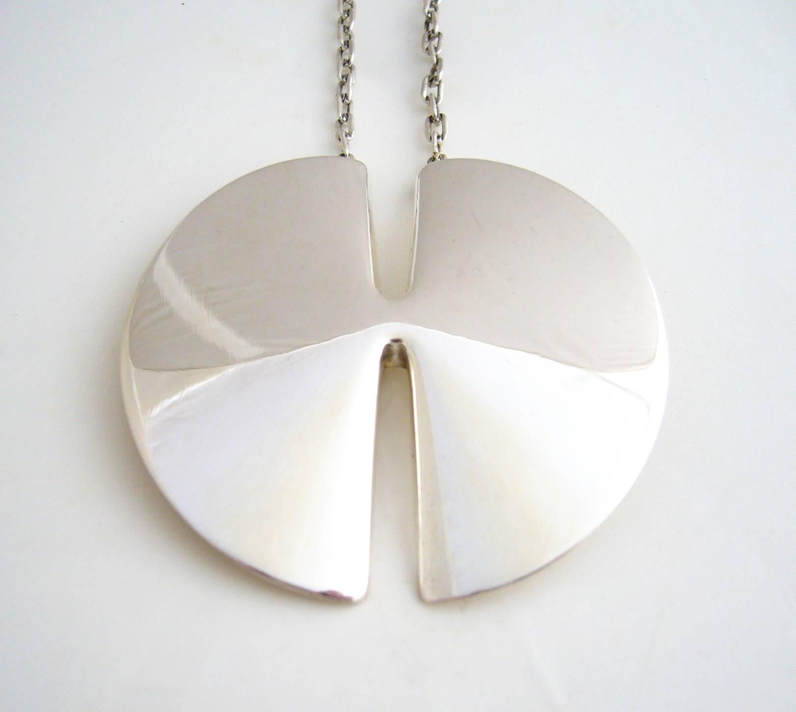 Sterling silver split disc necklace designed in 1958 by Nanna and Jorgen Ditzel for Georg Jensen.  Pendant measures 2.5