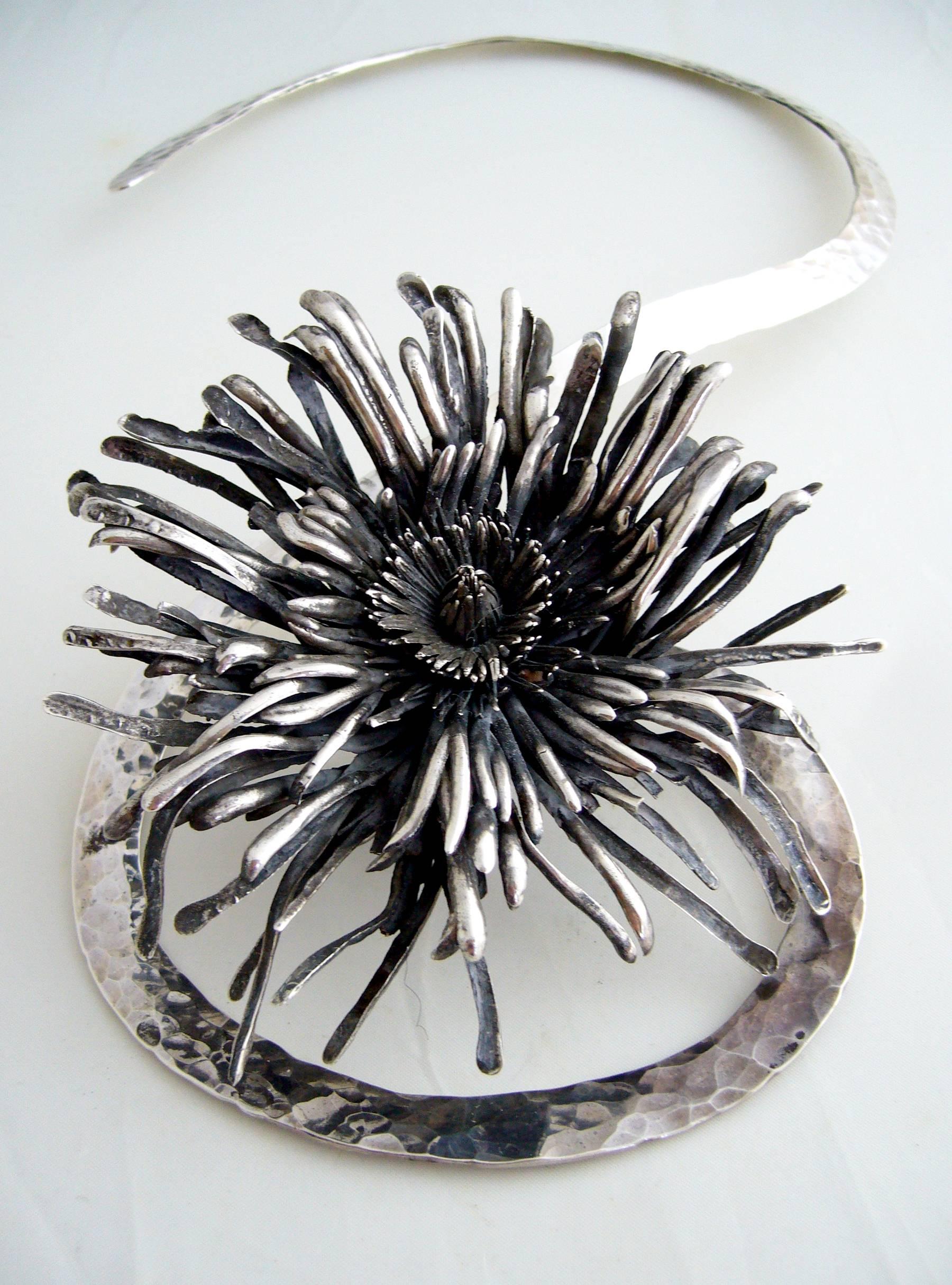 Large scale sterling silver chrysanthemum necklace created by Aaron Rubinstein, circa 1980's.  Torque curls around the back of the neck and continues into a pendant drop of about 5.5