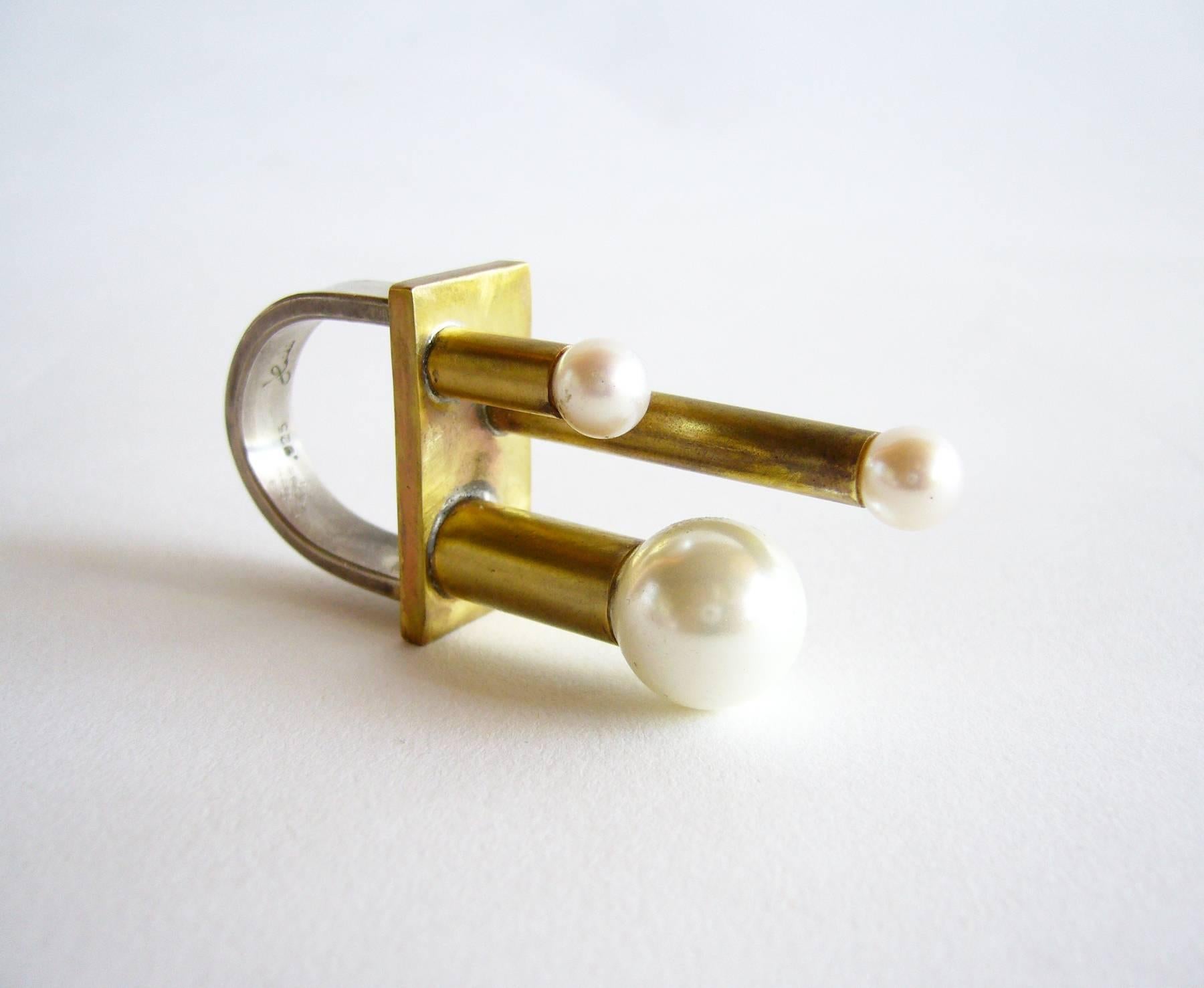 Sterling silver, brass and pearl ring created by Heidi Abrahamson of Phoenix, Arizona.  Ring is a finger size 7.5 and sits 1.5