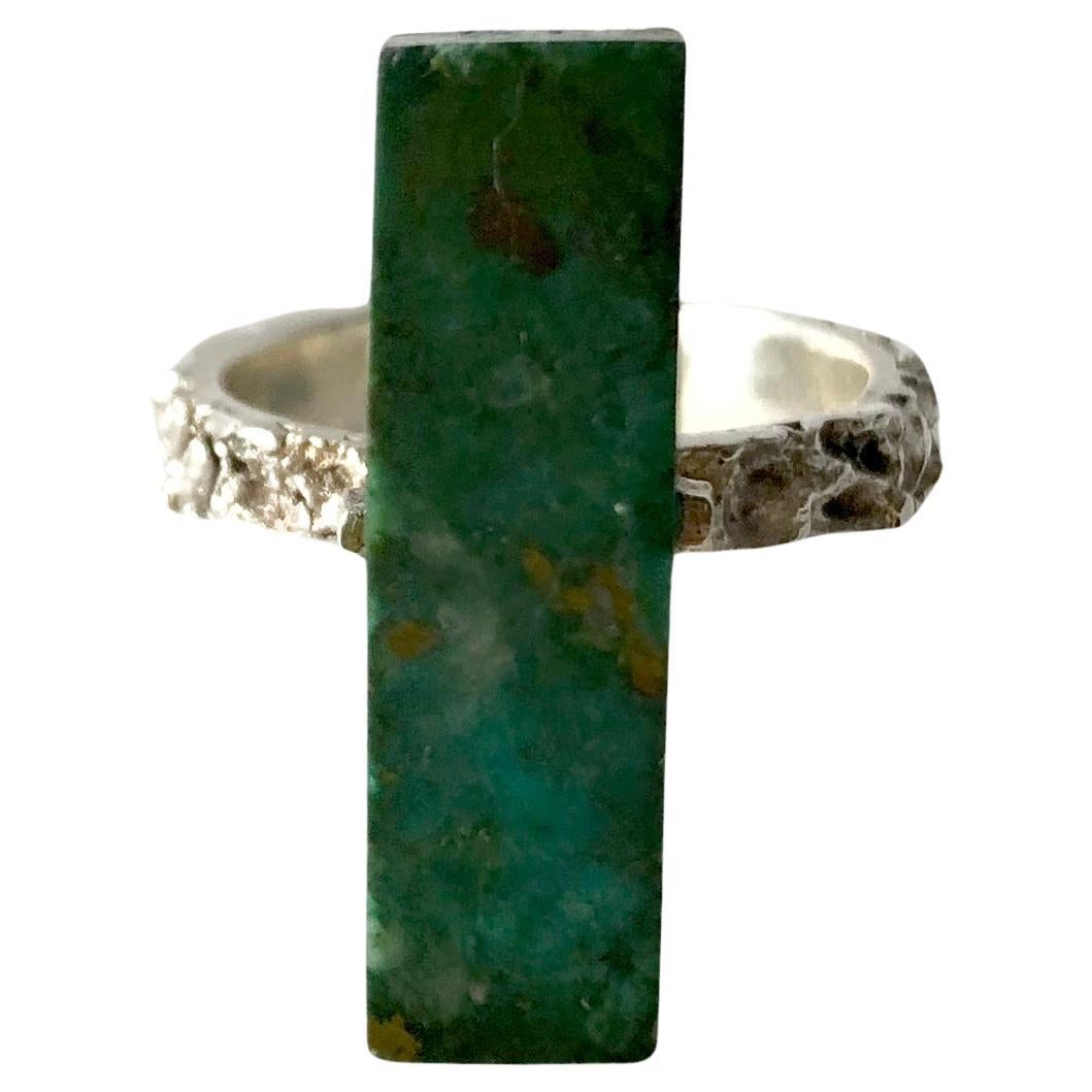 Heavily textured sterling silver ring with rectangular six sided malachite stone mounted on a sterling plank.  Ring is a finger size 7.5 and signed Peru, 925.  In very good vintage condition.  