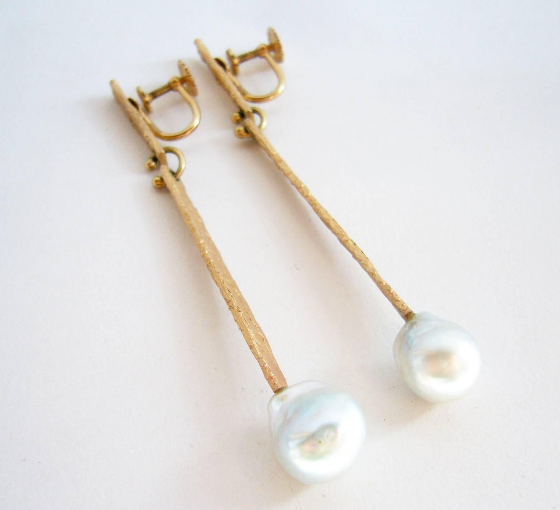 Textured 14k gold and grey mabé pearl earrings created by Ed Wiener of New York. Earrings measure 3