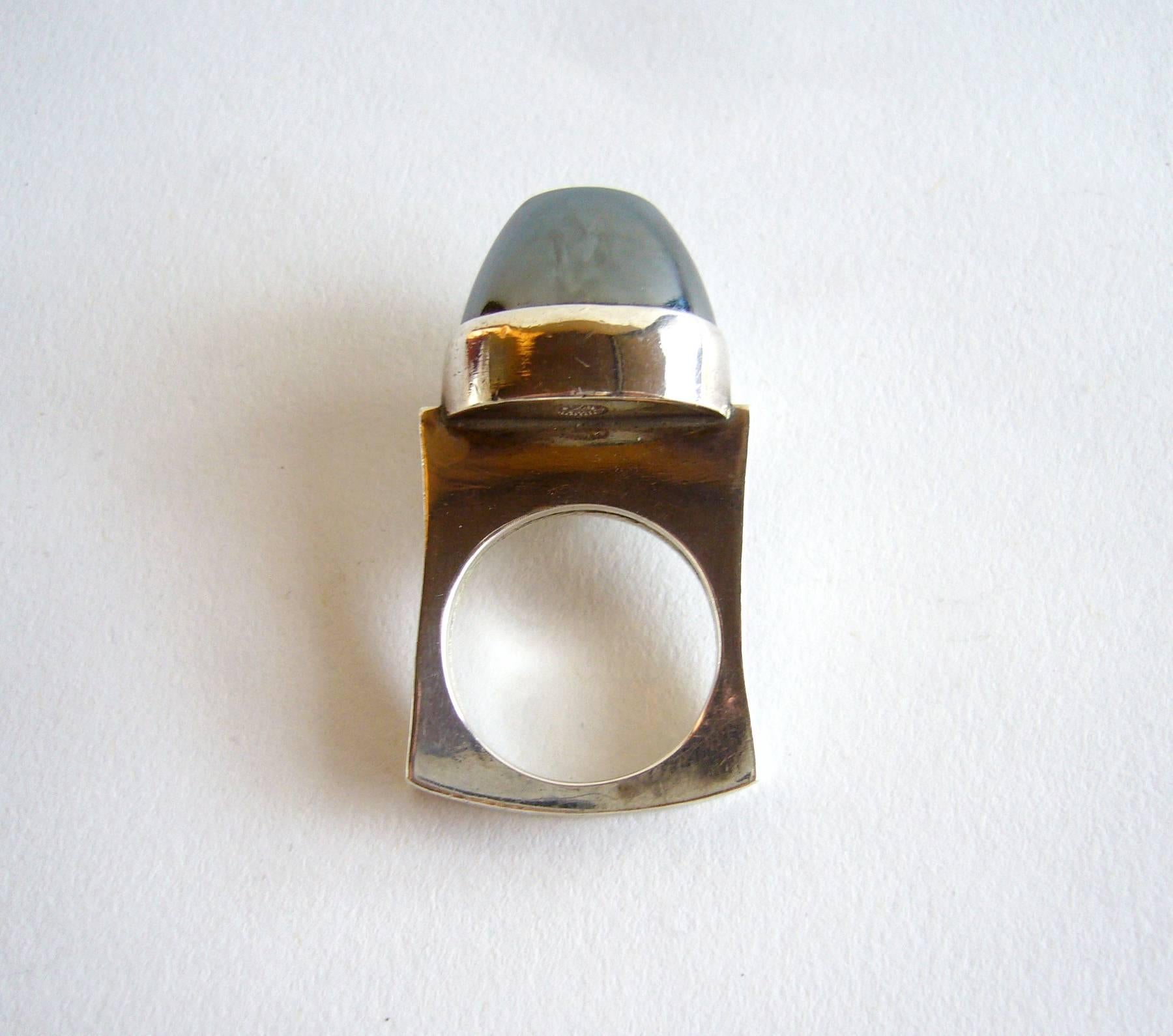 Sterling silver and hematite ring created by Danish modernist jeweler Andreas Mikkelsen for Georg Jensen.  Ring is a finger size 6.5 and is signed Georg Jensen, Denmark, 89A.  In excellent vintage condition.