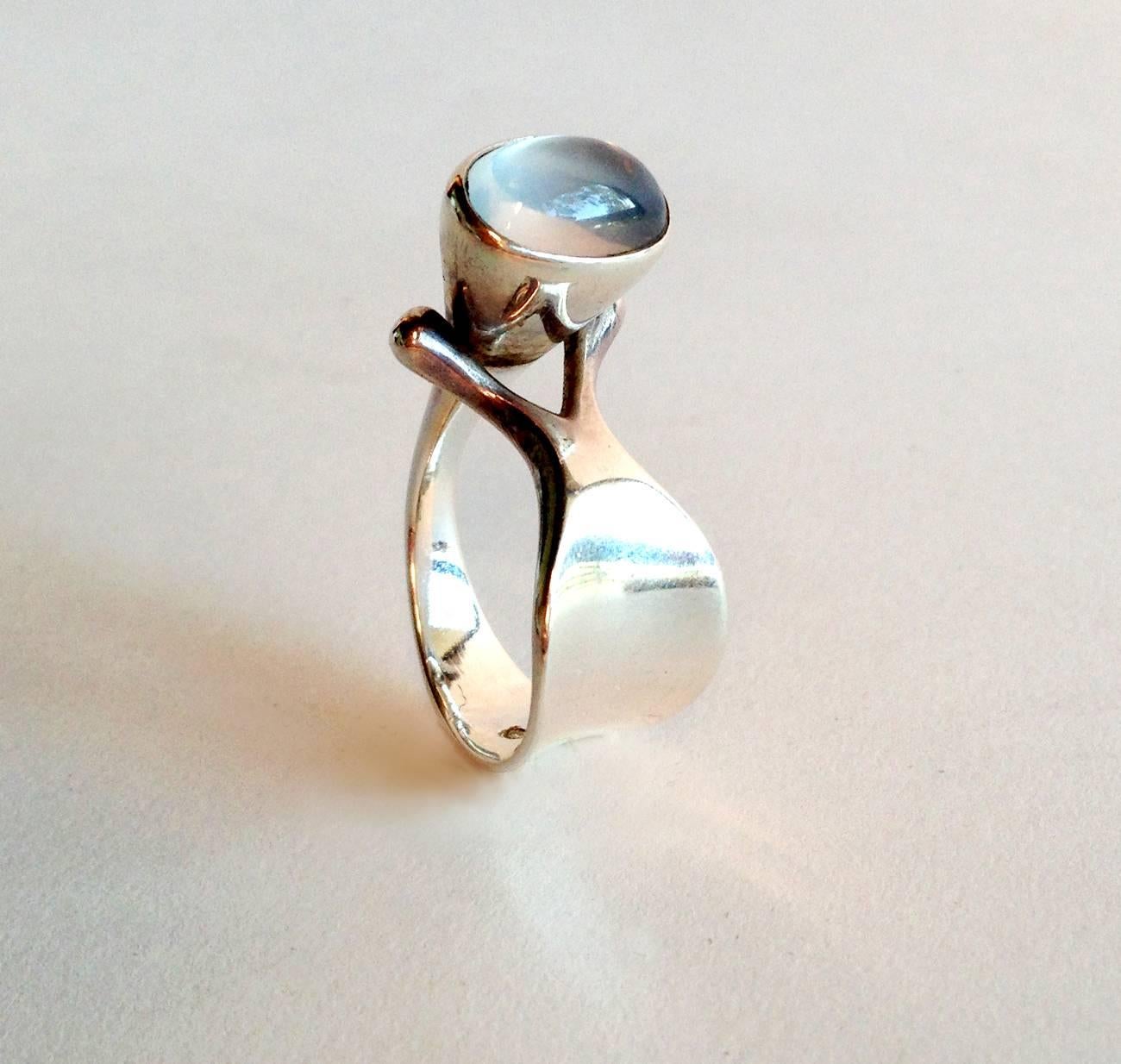 Dew drop moonstone ring designed Vivianna Torun Bülow-Hübe for Georg Jensen of Denmark.  Ring is a finger size 7 and is slightly adjustable.  Signed Georg Jensen, Denmark, 152.  In very good vintage condition.