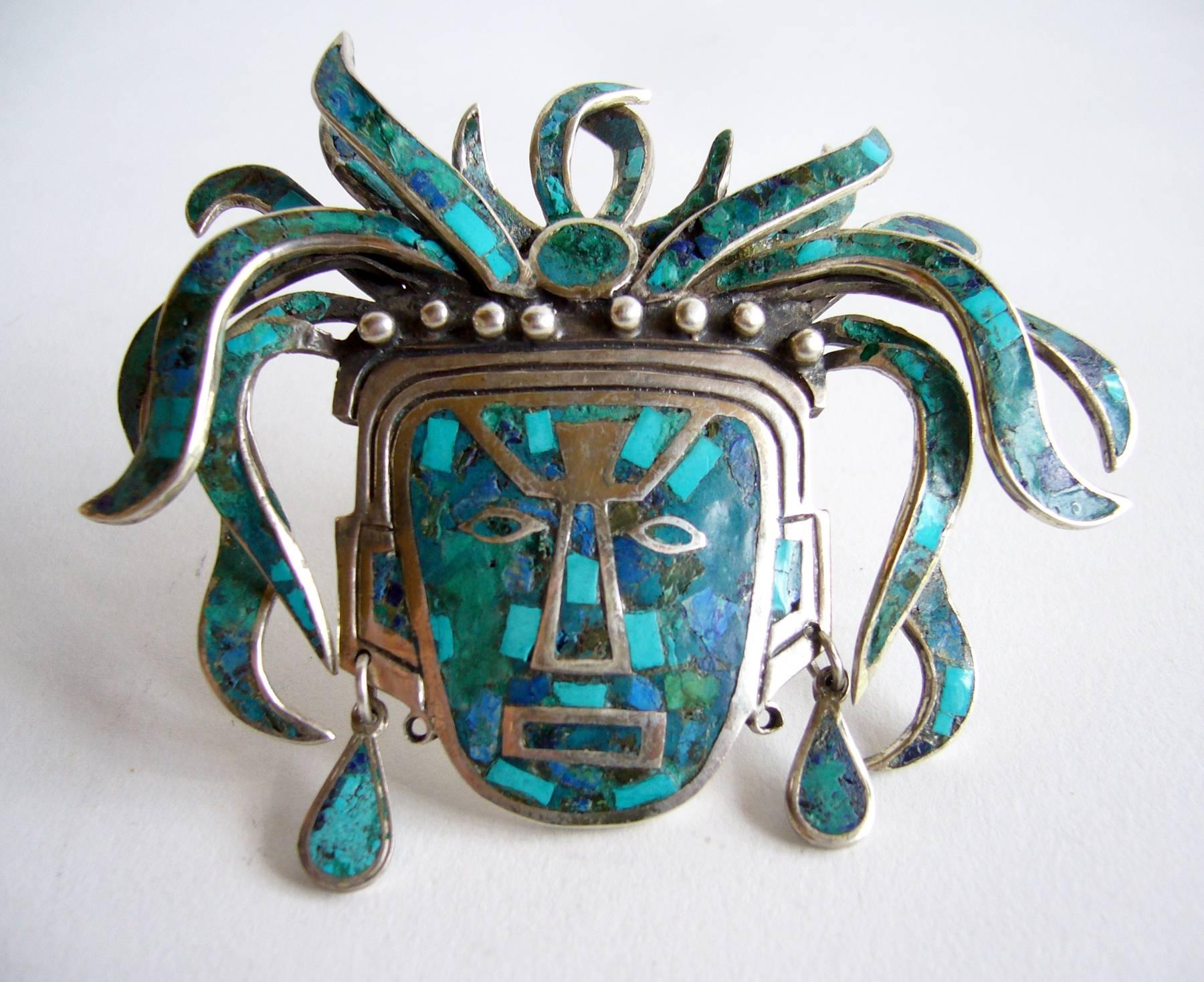 Sterling silver Mexican Aztec warrior brooch or pendant, inlaid with turquoise and lapis lazuli created by Cecilia for Toño circa 1950's.  Piece measures 3