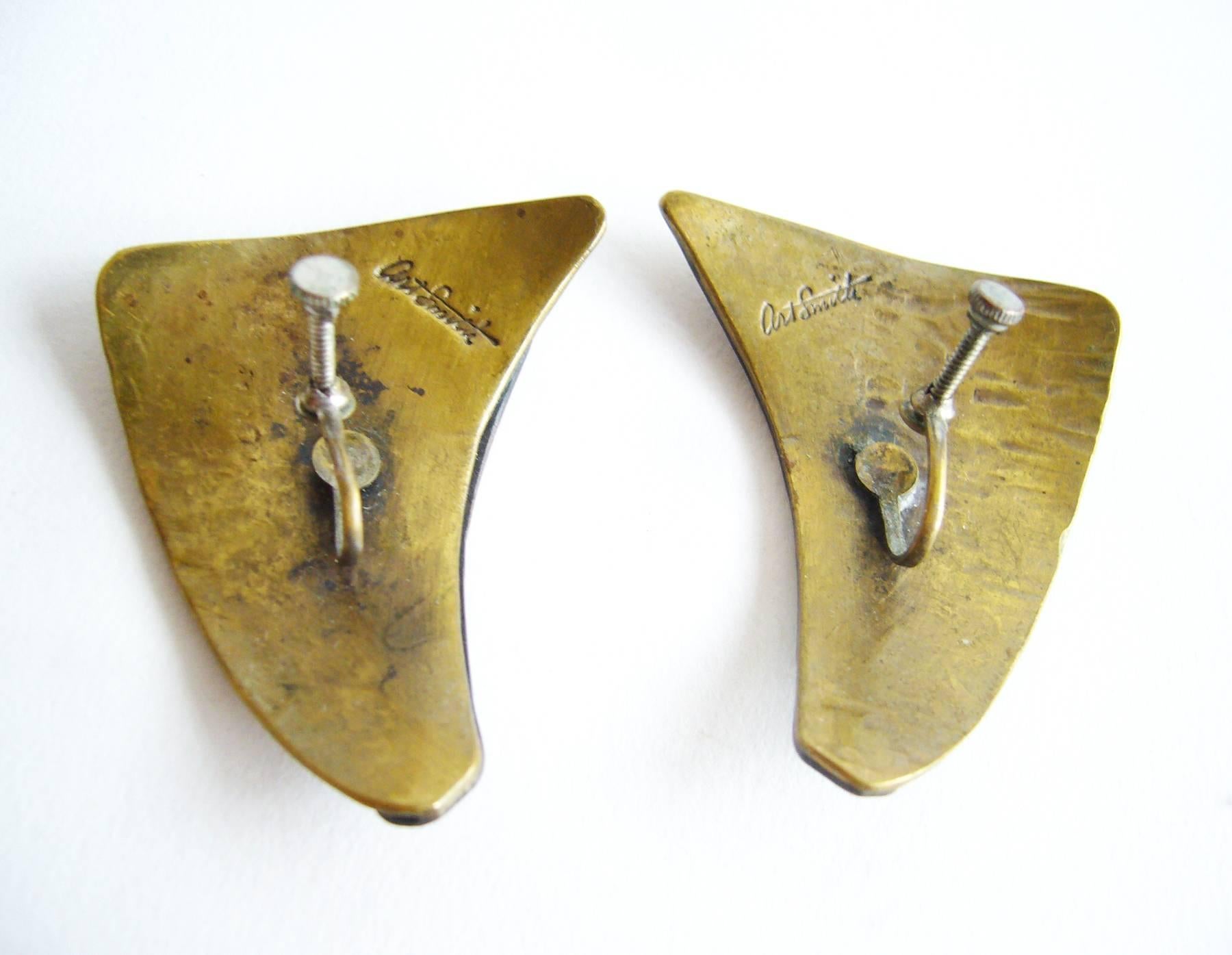 Pair of patinated copper and textured brass screwback earrings created by Art Smith of New York, New York.  Earrings measure 2