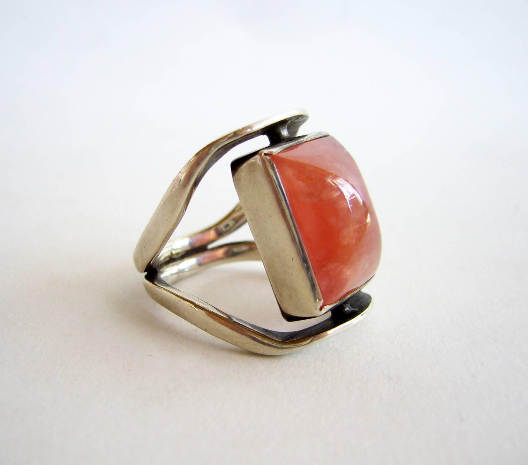 Sterling silver and fall color rhodochrosite ring created by Jack Nutting of San Francisco, California.   Ring is unsigned and a finger size 6.5 - 6.75.  From the estate of the artist, Jack Nutting.  In excellent vintage condition. 

Nutting joined