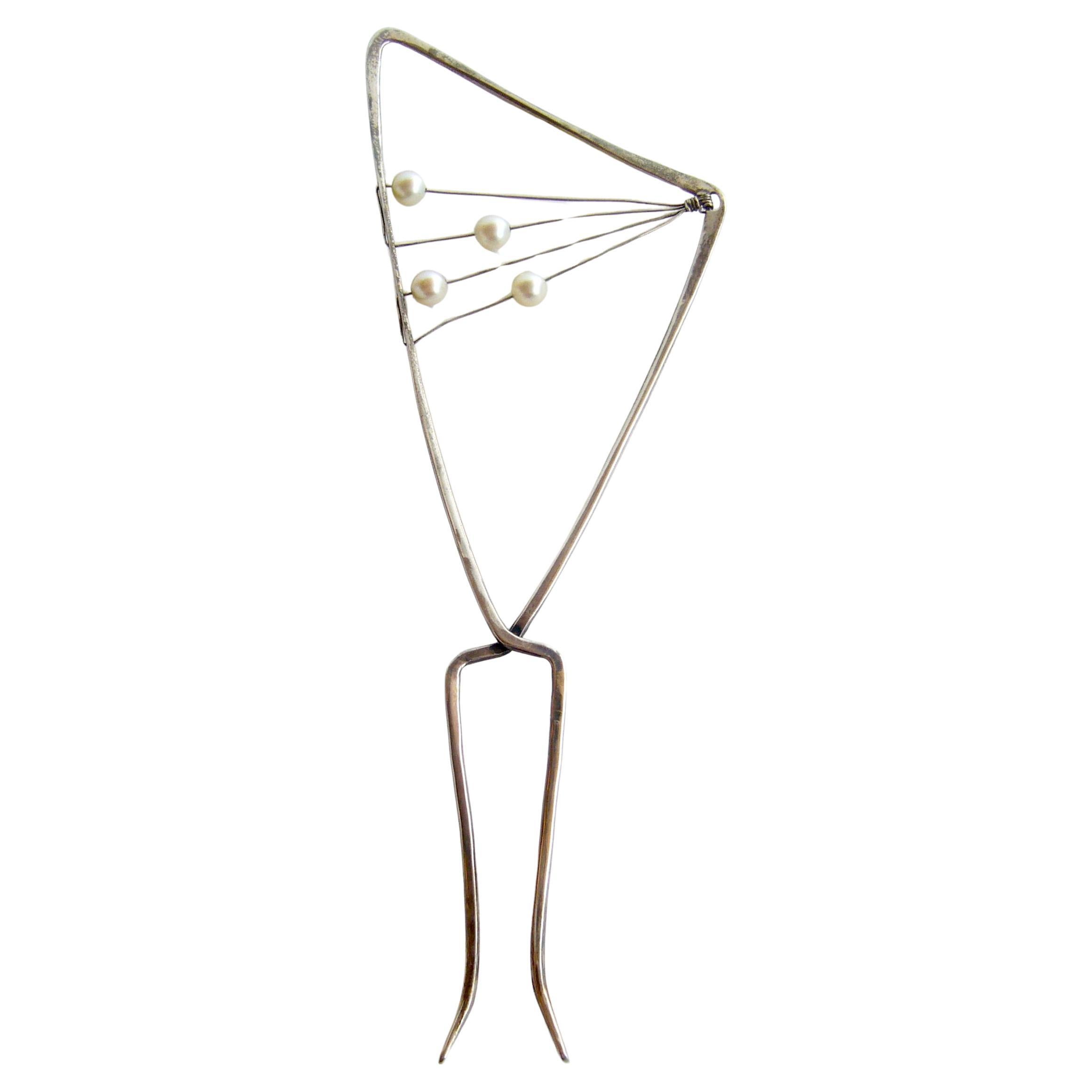 Handmade sterling and pearl hair comb created by Jack Nutting of San Francisco, California.  Comb features four pearls that move along silver wire.  It measures 7.25
