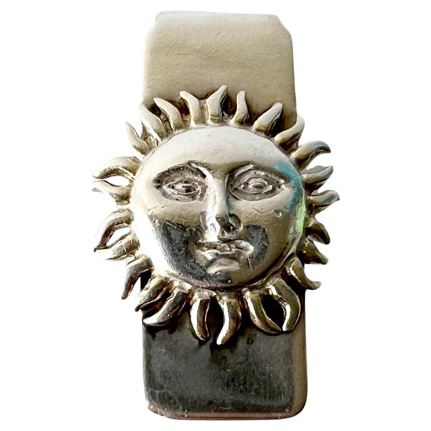 Sterling silver money clip with sun face decoration created by Sergio Bustamante of Mexico. Clip measures 2