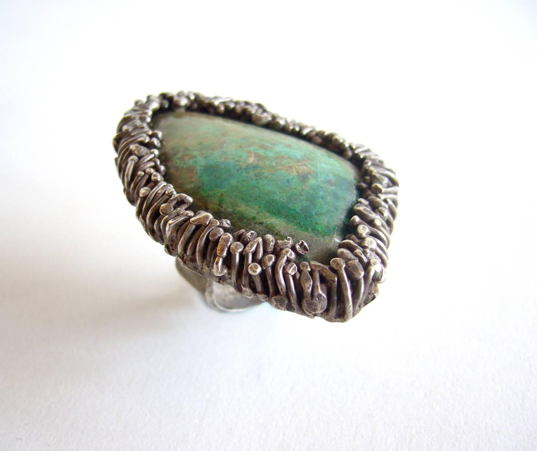 Large natural turquoise stone set in a silver textured frame created by Pal Kepenyes of Acapulco, Mexico.  Ring is a finger size 6 while the top of the ring measures 2