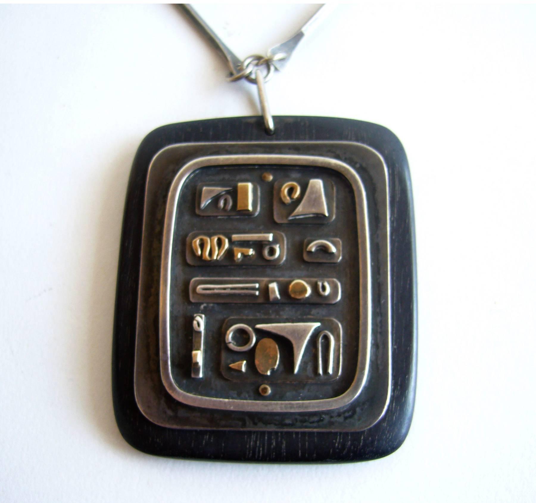 A rare, American modernist modernist sterling silver and exotic wood necklace, circa 1950's, designed by Irvin and Bonnie Burkee of Arizona.  Necklace is comprised of abstract sterling silver pieces, some with gold wash, attached to a sterling plate