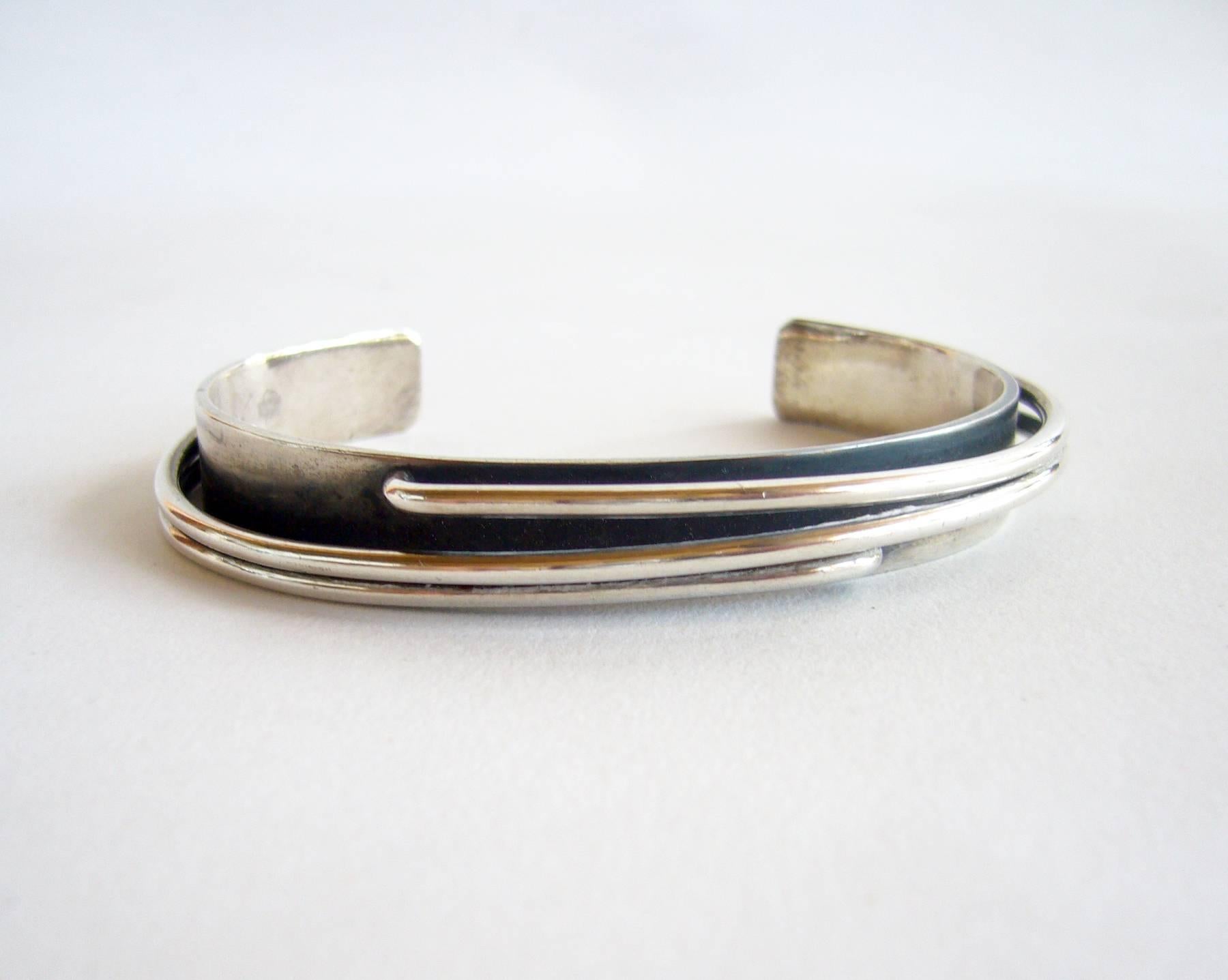 Handmade sterling silver narrow cuff bracelet created by Jules Brenner of New York City, NY.  Cuff measures 3/8