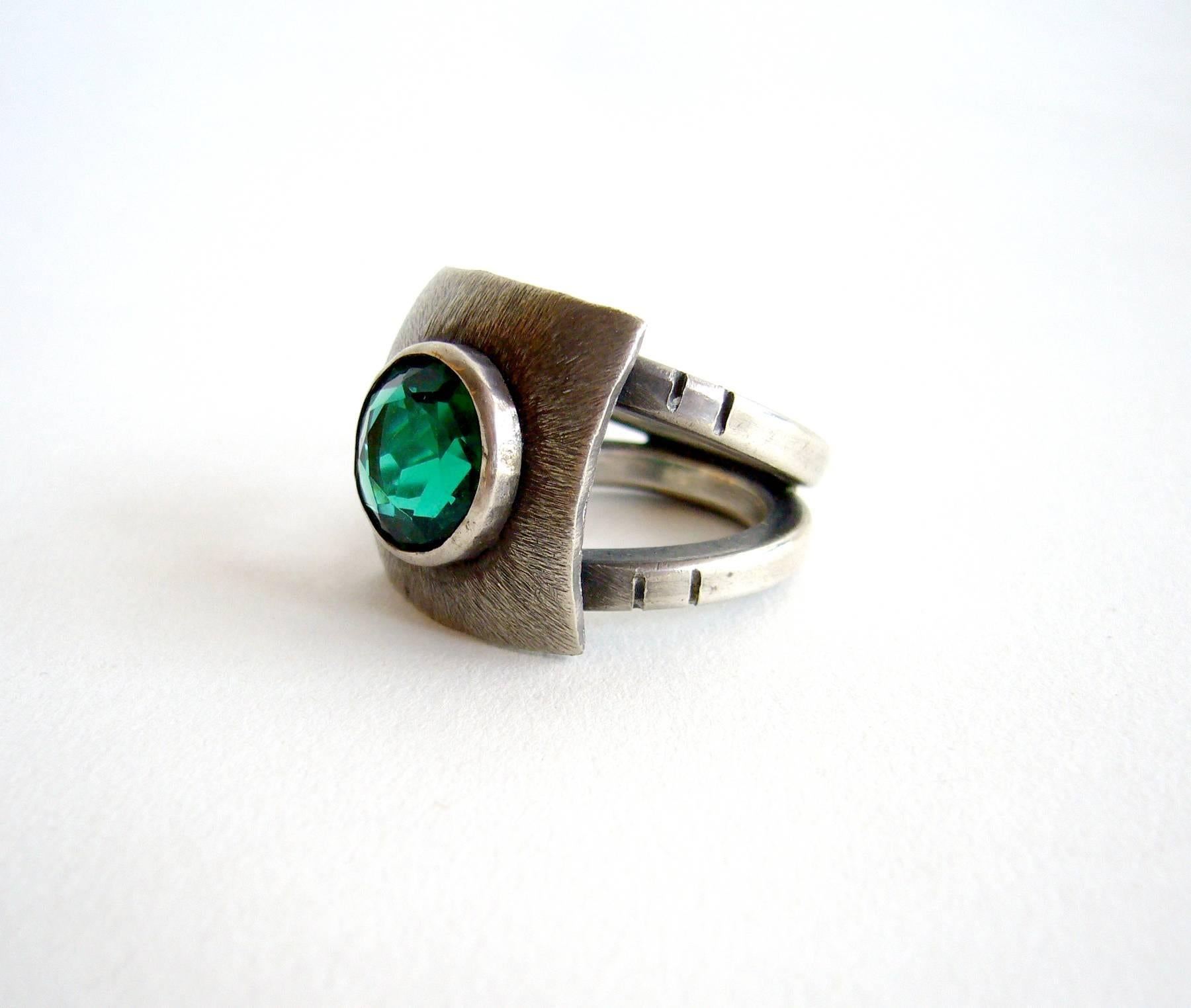 Hand textured sterling silver ring with faceted emerald color quartz created by silversmith James Parker of San Diego, California.  Parker was an early member of the Allied Craftsmen of San Diego which started in the 1940's.  His jewelry was