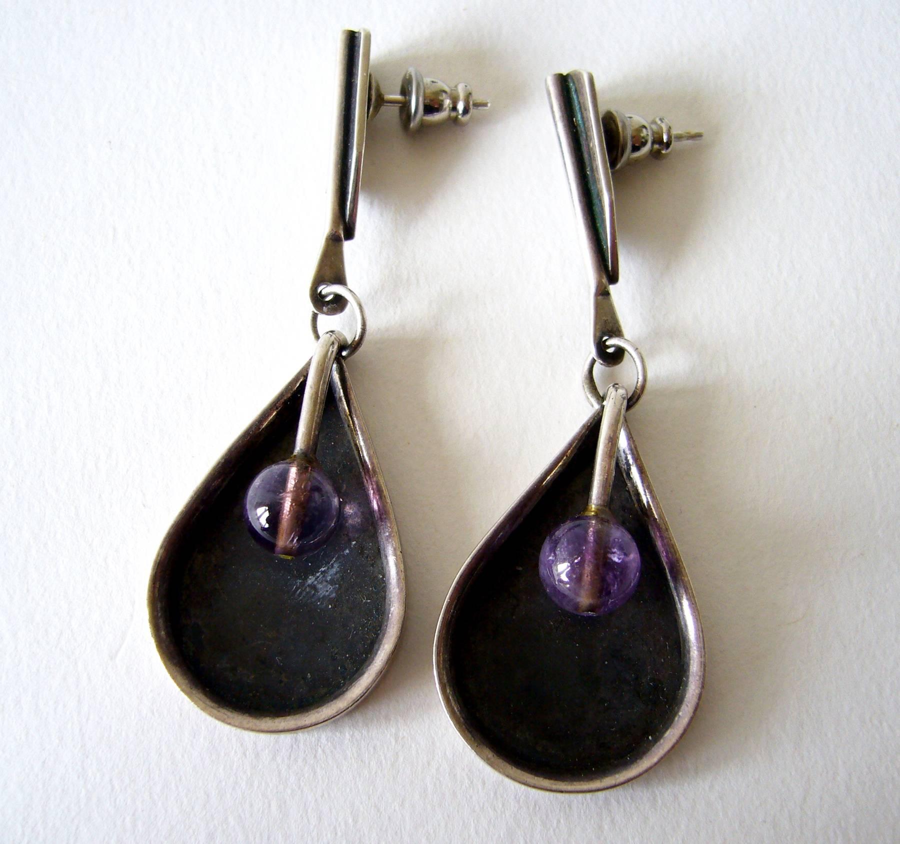 Amethyst and sterling silver pierced earrings designed by Jules Brenner of New York City, New York.  Earrings measure 2.25" in length and are signed Jules Brenner, Sterling.  In very good vintage condition.  