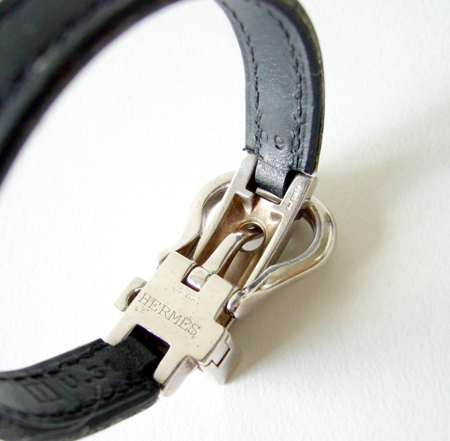 Hermes sterling silver and leather saddle buckle bracelet with locking safety.  Bracelet has 7