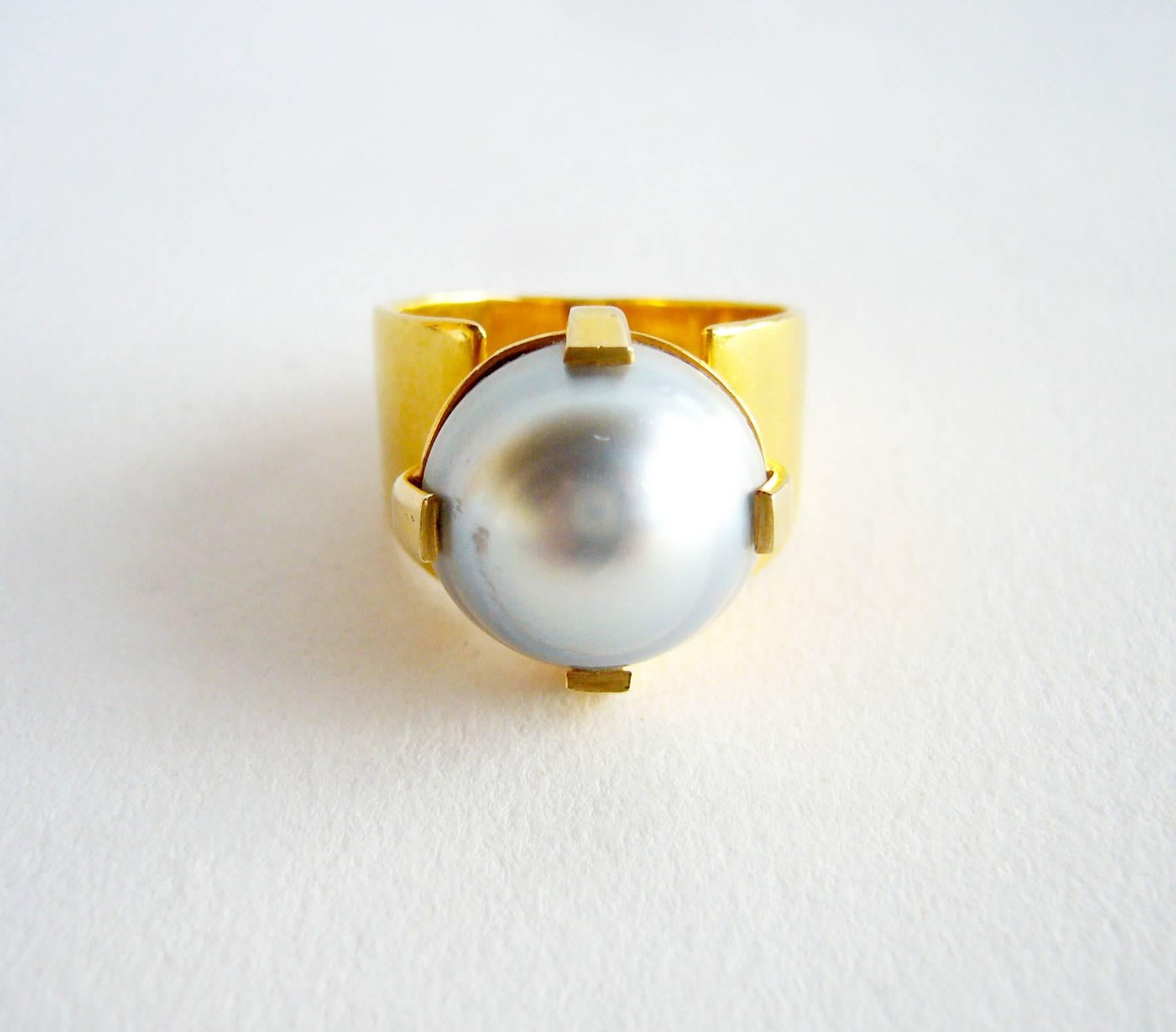 An 18k gold grey baroque pearl ring, circa 1960's.  Ring is a finger size 5.5 and is unsigned.  An unconventional alternate to a modern day wedding or engagement ring.  In very good vintage condition. 4.9 dwt.  