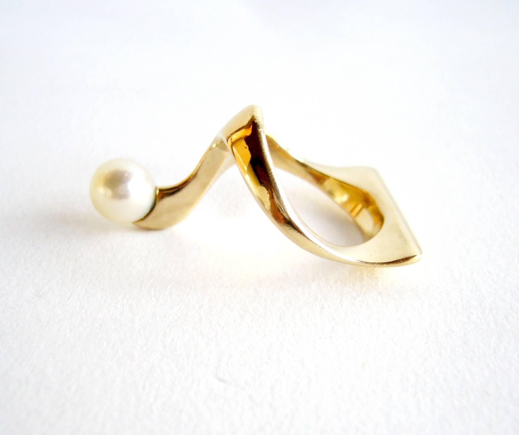 14k gold and pearl American modernist ring, circa 1950's.  Ring is reminiscent of designs by Ed Wiener of NYC. A finger size 5 - 5.25 and has a partial signature of -Mc, 14k.  In very good vintage condition.