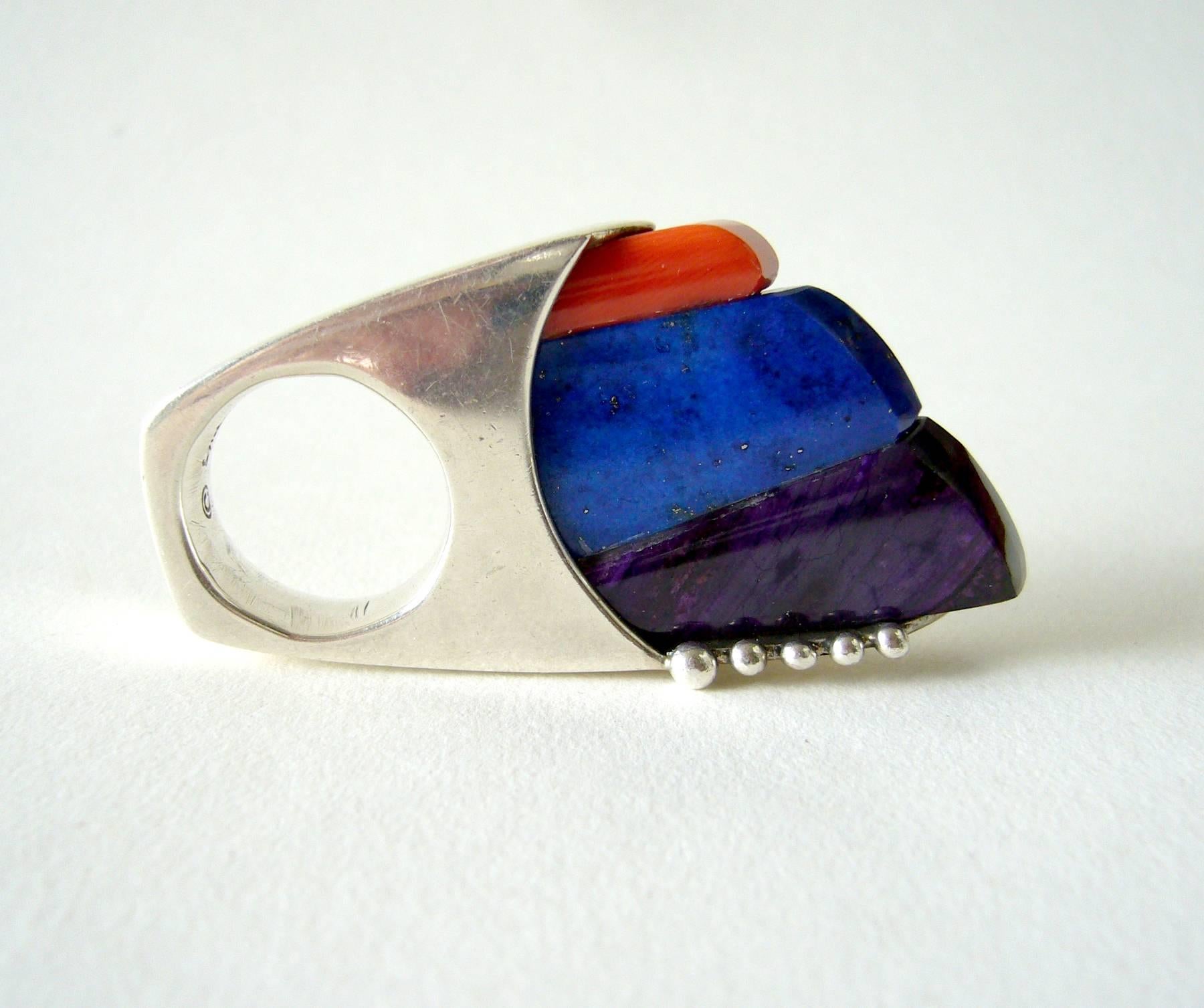 Sterling silver lapis lazuli, coral and suglite ring by contemporary Native American Navajo jeweler, Lyndon Tsosie.  Ring is a finger size 5.5 and is signed Lyndon B. Tsosie, Sterling.  In very good condition.  