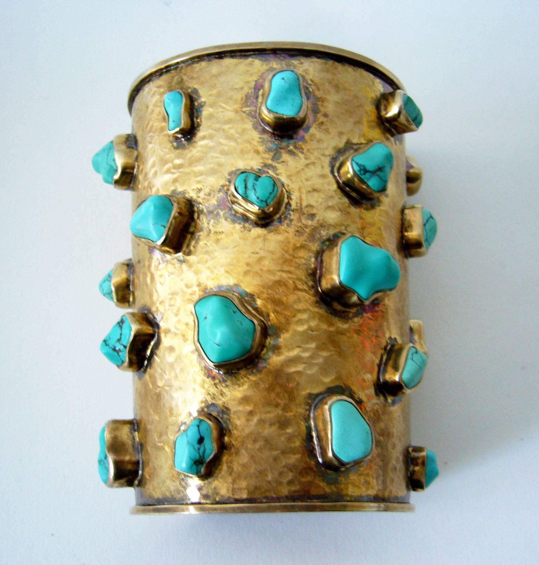 Sterling vermeil cuff bracelet featuring twenty five bezel set turquoise nuggets within, created by Celia Harms of Vera Cruz, Mexico.  Cuff is 4.5" wide and has a wearable wrist length of 8" at the small end.  It will fit a medium to large