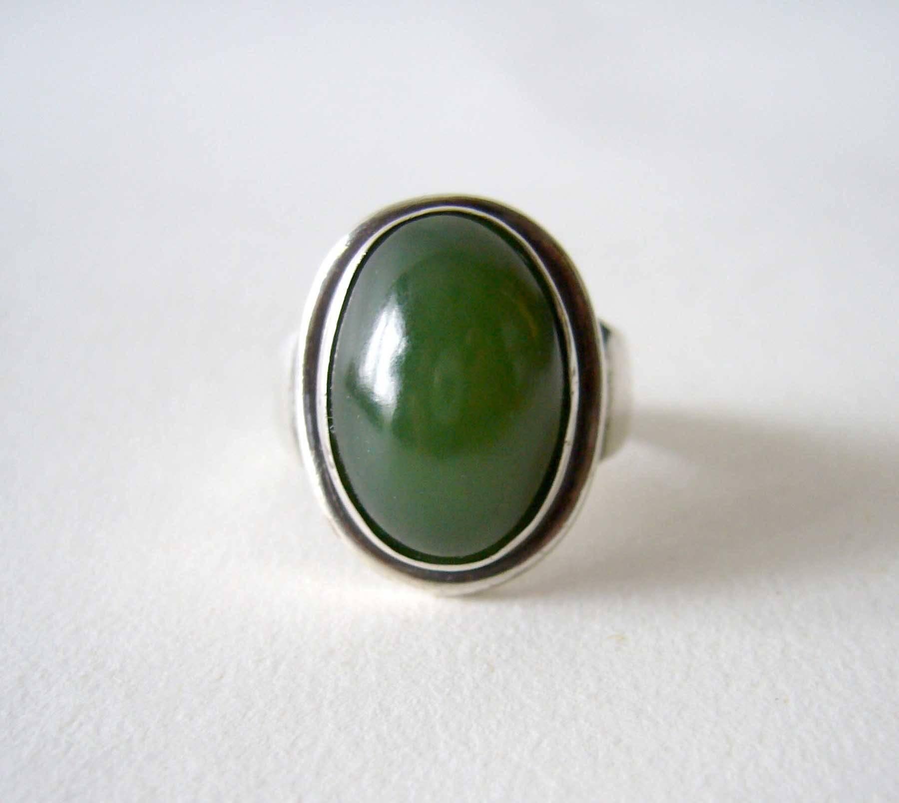 Sterling silver and jade ring designed by Harald Neilsen for Georg Jensen of Denmark.  Jade is of the nephrite variety and in very good condition.  Ring is a finger size 9.5 to 9.75 and is signed with oval mark of Georg Jensen, Denmark, Sterling,