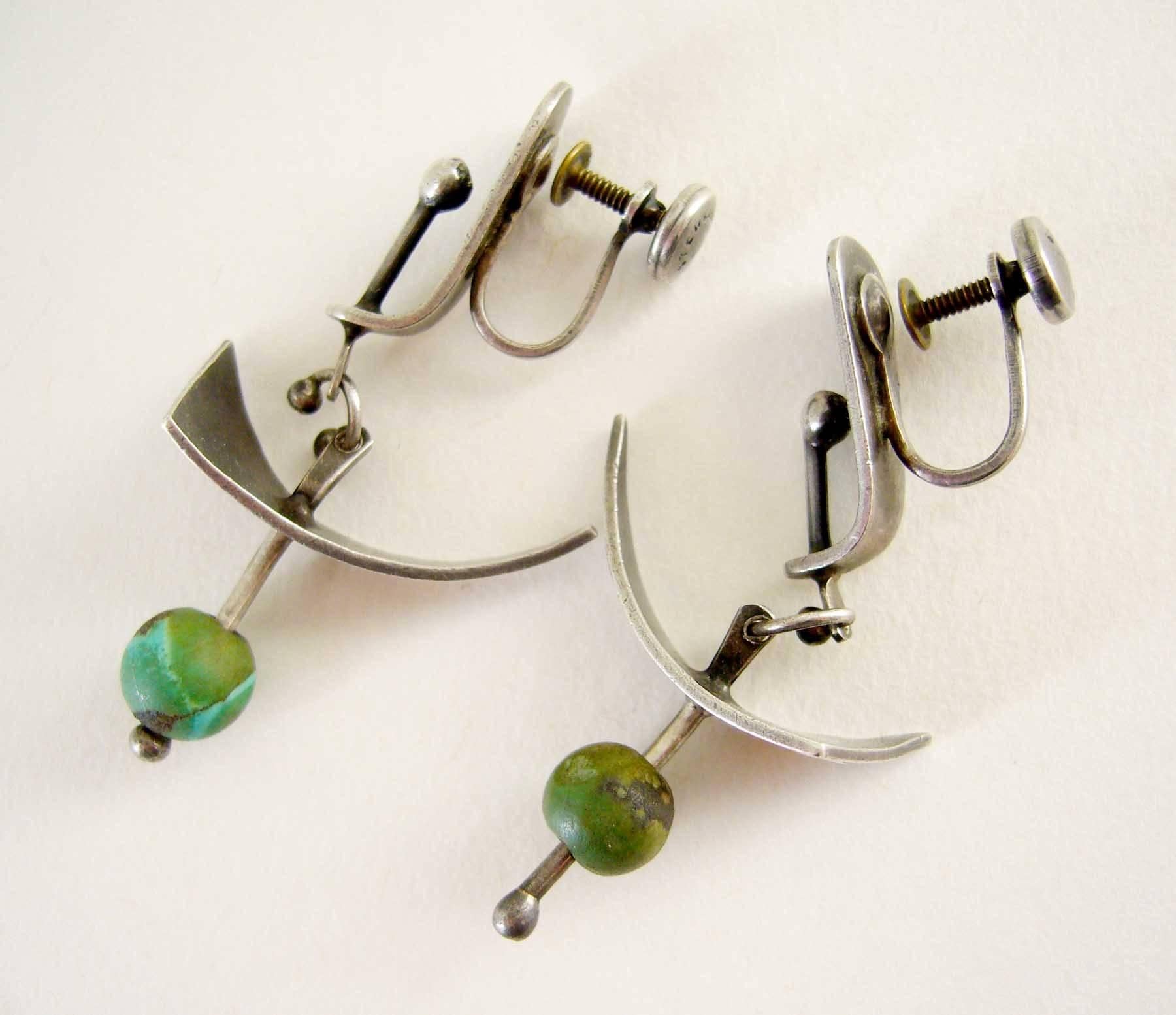 Abstract modern screwback earrings in sterling silver with turquoise bead accent circa 1950's.  Earrings were created by Ed Wiener of New York City, New York and measure 1.75