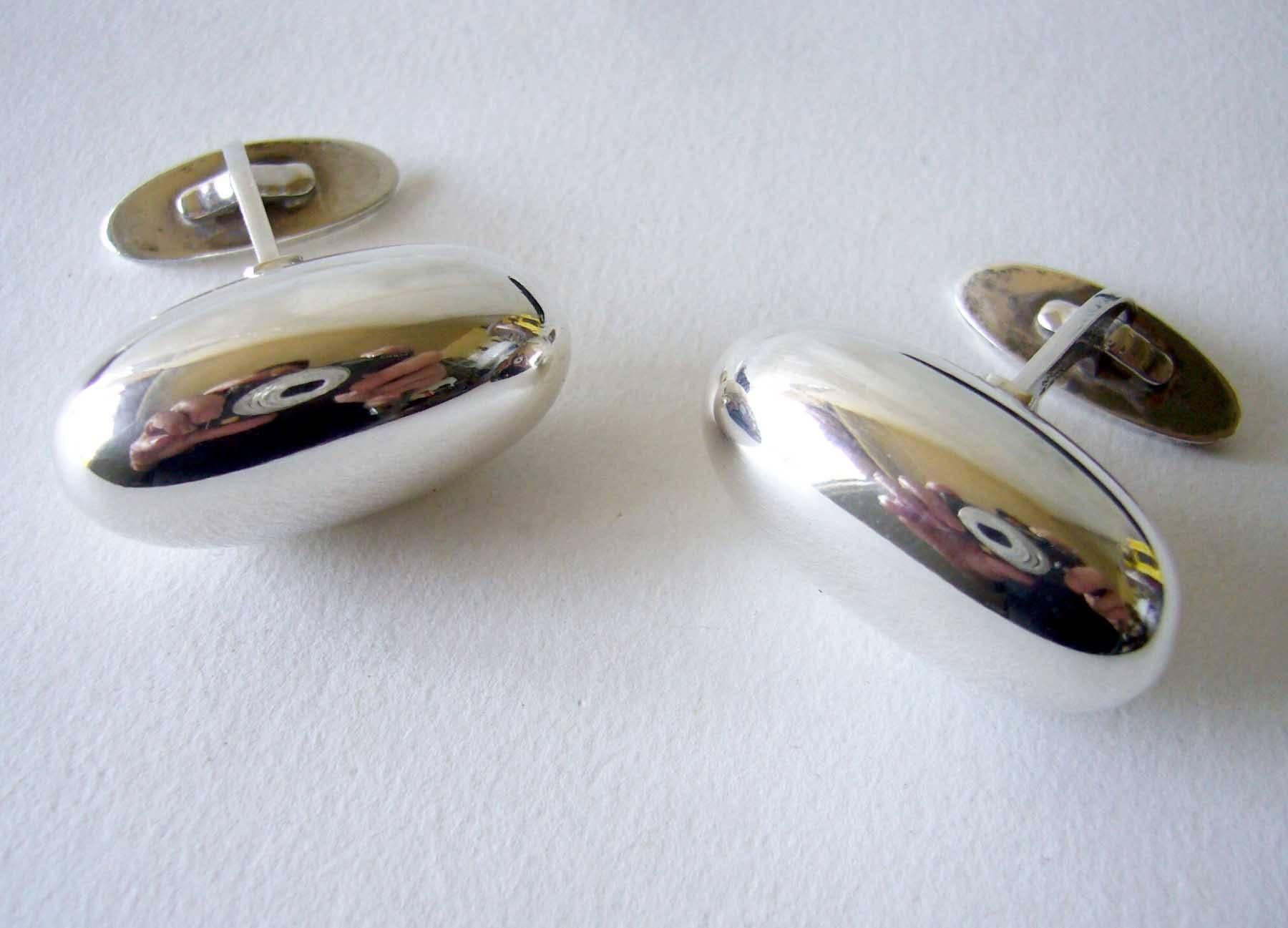 A pair of sterling silver cufflinks designed by Vivianna Torun Bülow-Hübe for the Georg Jensen Silversmithy, Denmark.  Cufflinks are the longer version of this design measuring 1 1/4