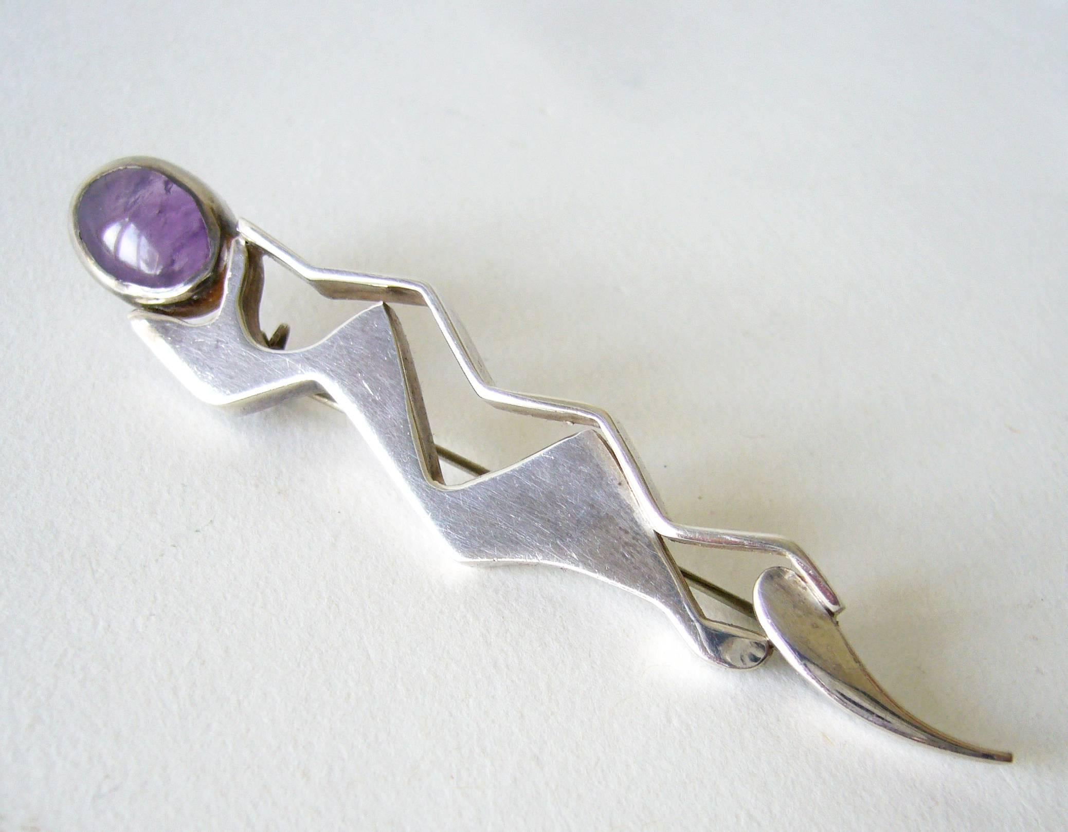Sterling silver with amethyst cabochon created by Suzanne Somogy of Paris, France circa 1970's.  Brooch measures 3.25" long by .75" and is signed Somogy on verso.  Acquired from the estate of the artist, Suzanne Somogy.  In very good