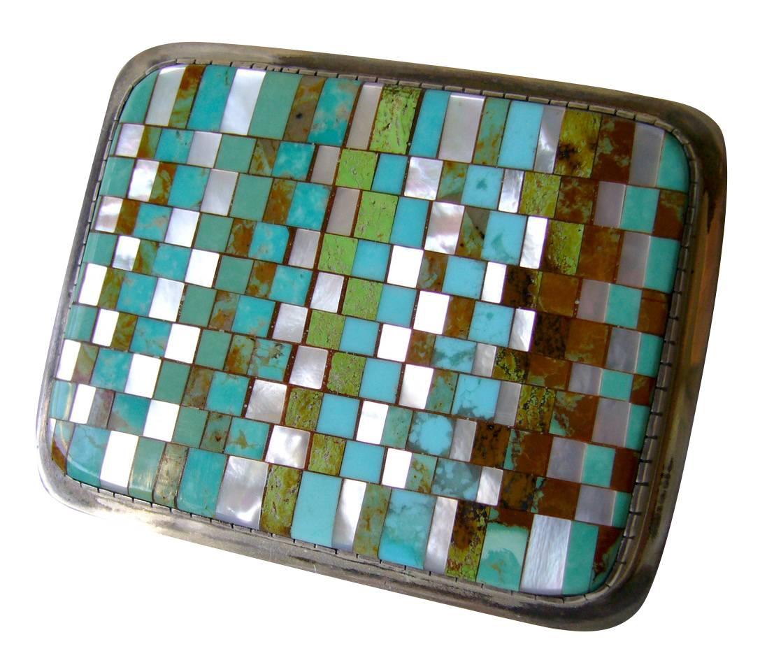Mosaic belt buckle made from turquoise, coral and mother-of-pearl inlay created by Charlie Bird of the Santo Domingo Pueblo, Sandoval County, New Mexico.  Belt buckle is of superior quality and measures  2" by 2 1/2" by  3/16" thick. 