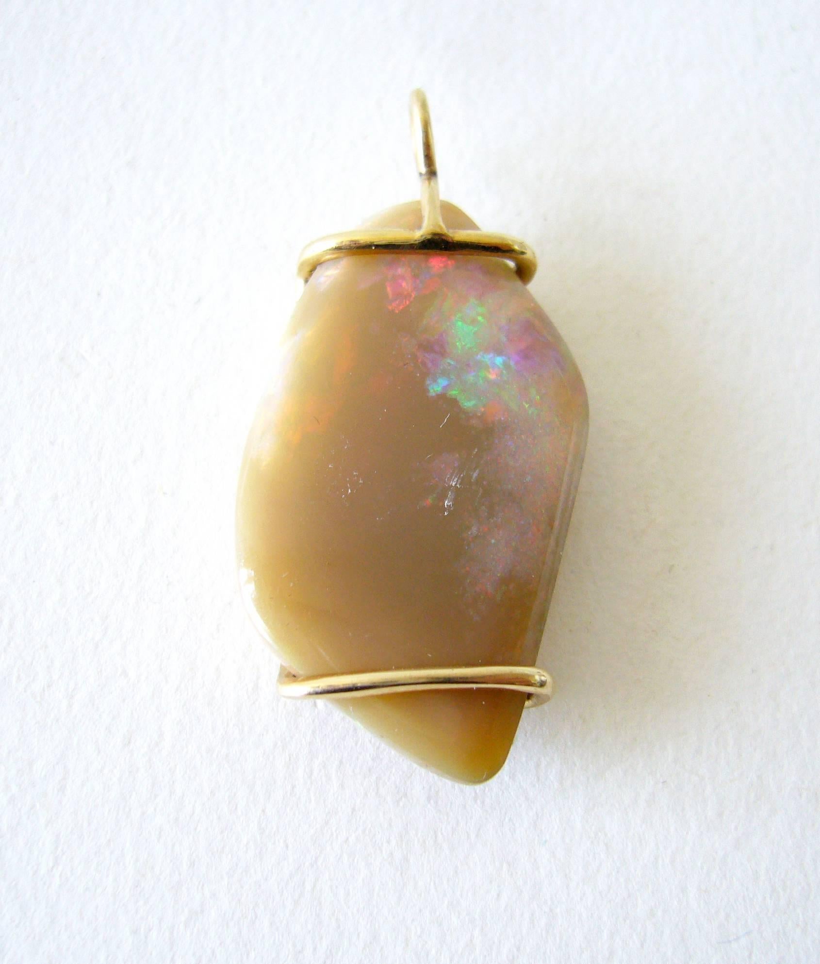 Opal pendant wrapped in 14k gold with abstract design, made by mid century jeweler Jack Nutting of San Francisco, California.  Pendant measures 1.5