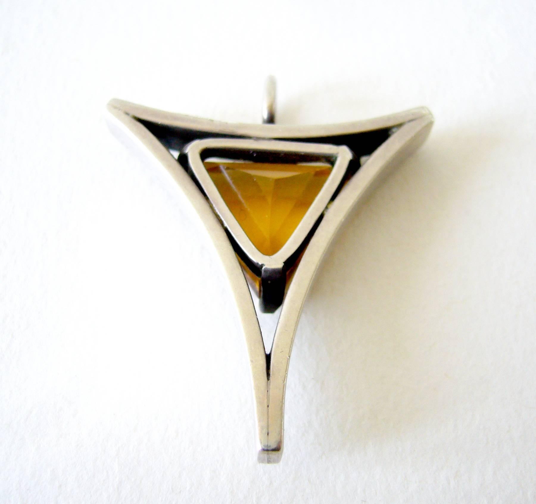 Faceted triangular shaped topaz or quartz stone set in sterling silver and open frame pendant created by Jack Nutting of San Francisco, California.  Pendant measures 1.5