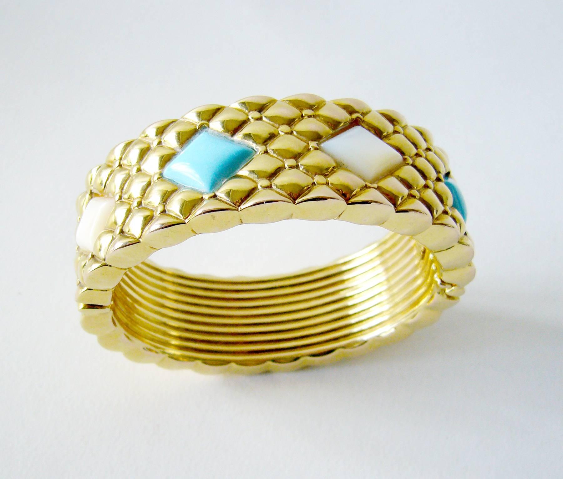 Italian creator hollow 14kt. gold, Persian turquoise and mother of pearl hinged bracelet with quilted diamond shaped design.  Bracelet consists of eight large diamond shaped gemstones.  Measuring about 1" wide and will fit up to a 7" wrist