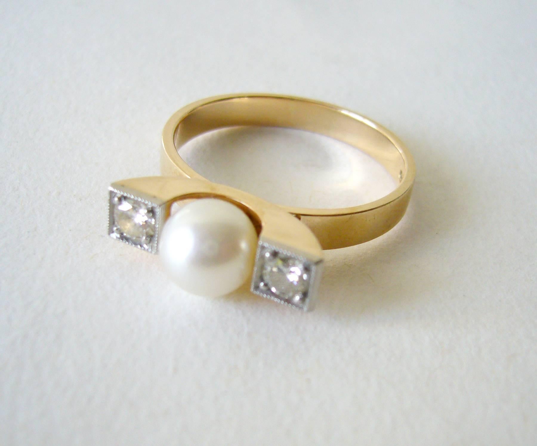 Finnish modernist 14k gold ring with diamonds and 7mm pearl created by Elis Kauppi for Kupitaan Kulta.  Ring is a finger size 9.5 and is signed with the Anvil mark for Kupitaan Kulta, S7 (1971), 585.  Suitable for a modern day engagement or wedding