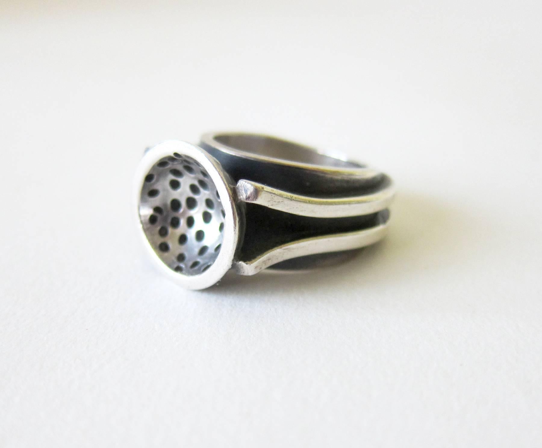 Sterling silver modernist ring created by James Parker of San Diego, California. Ring is a finger size 8 and is signed with the conjoined JP cypher, Hand Made, Sterling.  Suitable for a man or woman and in very good vintage condition.

