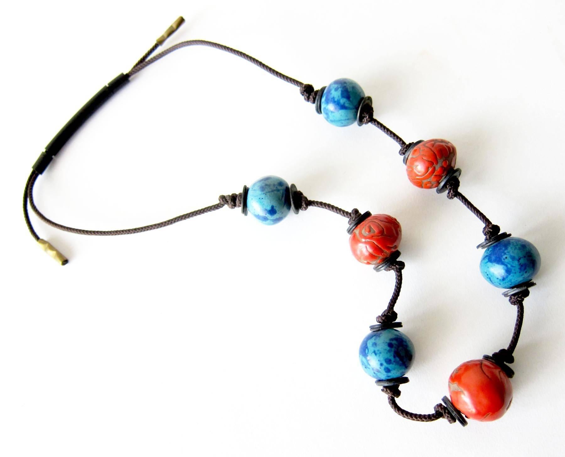 Original, vintage seven ceramic bead necklace separated by metal washers and knotted rope created by Doyle Lane of Los Angeles, California.  Necklace measures 26